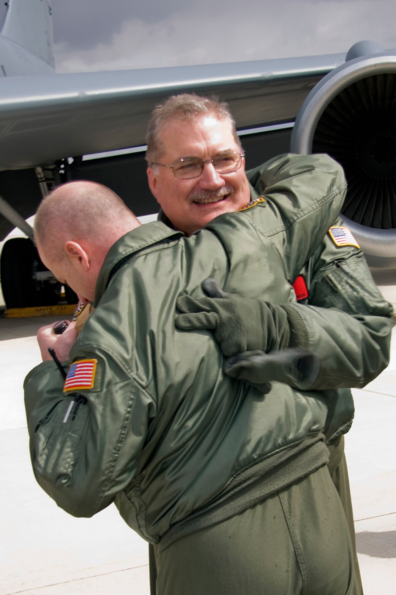 GRISSOM AIR RESERVE BASE, Ind. --  Chief Master Sgt. Jeff Maier hugs Senior Master Sgt. Paul "Doogie" Houser here shortly after Sergeant Houser completed his 10,000th flight hour April 5. Friends, family and coworkers gathered together to congratulate Sergeant Houser, who began his Air Force career in 1976 as a communications and navigation maintenance specialist. Sergeant Houser cross trained to be an in-flight refueling technician, better known as a boom operator, in 1980 and joined the Air Force Reserve in 1985. He is now the in-flight refueling manager with the 434th Operations Support Squadron. Chief Maier is the 74th Air Refueling Squadron's in-flight refueling superintendent. (U.S. Air Force photo/Tech. Sgt. Mark R. W. Orders-Woempner)
