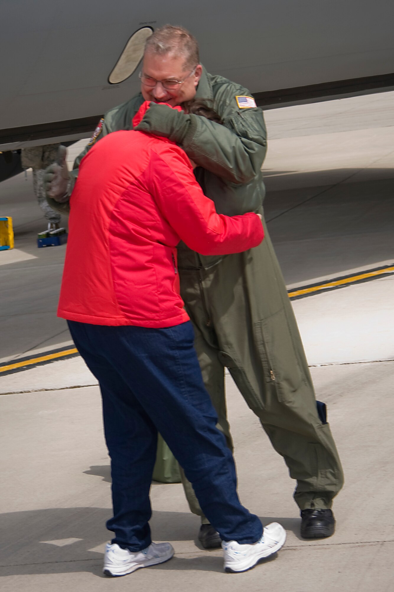 GRISSOM AIR RESERVE BASE, Ind. --  Laura Houser hugs her dad, Senior Master Sgt. Paul "Doogie" Houser, after racing out to be the first person to congratulate him on achieving his 10,000th flight hour April 5. Friends, family and coworkers gathered together to congratulate Sergeant Houser, who began his Air Force career in 1976 as a communications and navigation maintenance specialist. He cross trained to be an in-flight refueling technician, better known as a boom operator, in 1980 and joined the Air Force Reserve in 1985. (U.S. Air Force photo/Tech. Sgt. Mark R. W. Orders-Woempner)
