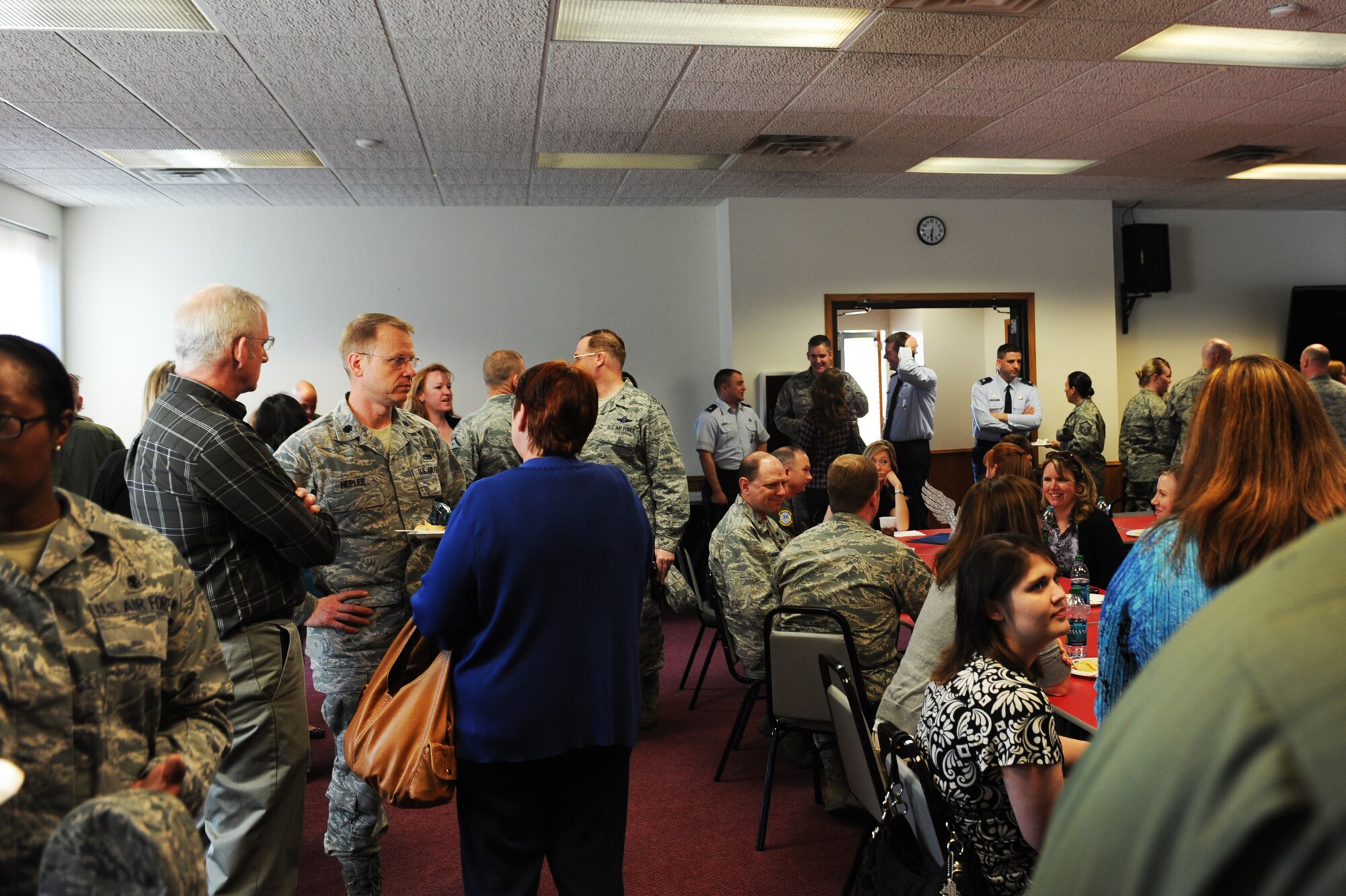 MINOT AIR FORCE BASE, N.D. -- Airmen and their spouses socialize during an event to show respect and appreciation for the key spouses here April 11. The Key Spouse Program here is designed to enhance mission readiness by supporting family members of deployed Airmen who are on remote tours or serving an extended temporary duty. (U.S. Air Force photo/ Airman 1st Class Aaron-Forrest Wainwright)