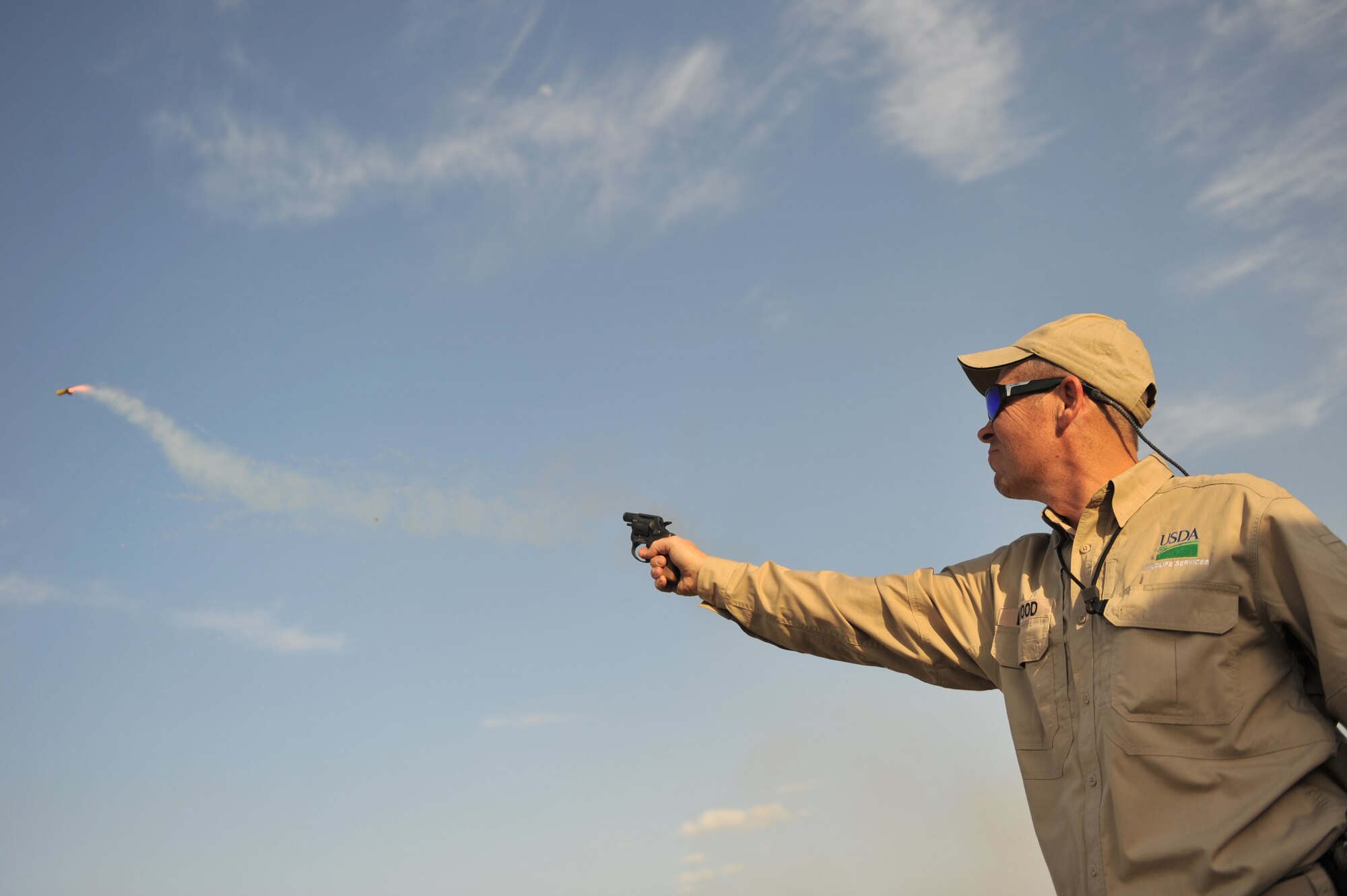 Mr. Eddie Earwood, U.S. Department of Agriculture Wildlife Services biologist, uses a pyrotechnic to disperse birds around the flight line at Bagram Airfield, Afghanistan, April 13, 2011. Mr. Earwood, assigned to the 455th Air Expeditionary Wing Safety, has diffused over 3600 birds since March using a non-lethal technique. (U.S. Air Force photo by Senior Airman Sheila deVera)