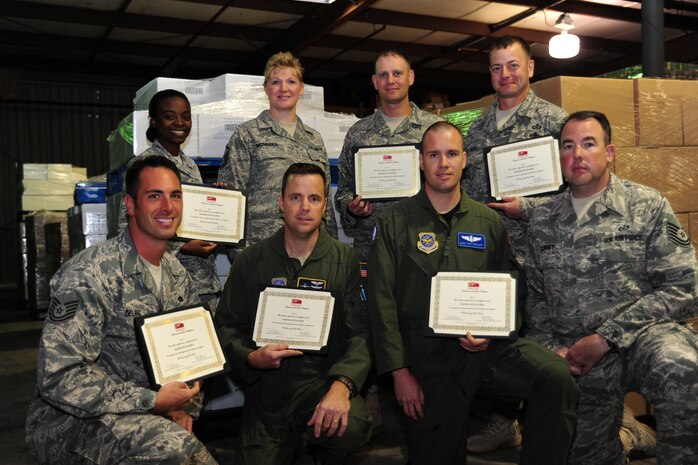 Eight Airmen, representing more than 200 Joint Base Charleston volunteers, accept the Volunteer of the Year award from the Lowcountry Food Bank April 13. The JB-CHS volunteers helped move more than 300,000 lbs of food, equaling 200,000 meals, out of the Food Bank and into the local community during 2010. Volunteers did administration work and packed boxes and backpacks full of food for children. 
Back row: Senior Airman Brittney Kelly, 628th Logistic Readiness Squadron, Master Sgt. Michelle McMeekin, 628th Force Support Squadron, Tech. Sgt. Michael Tate and Master Sgt. Michael Blair, both from the 437th Operation Support Squadron. Front row: Tech. Sgt. Shawn Delang, 373rd Training Squadron, Master Sgt. Donny Leydig, Career Assistance Advisor and Master Sgt. Troy Firzlaff and Tech. Sgt. Gregory Currey from the 437th Operations Support Squadron. (U.S. Air Force photo by Tech. Sgt. Chrissy Best)
