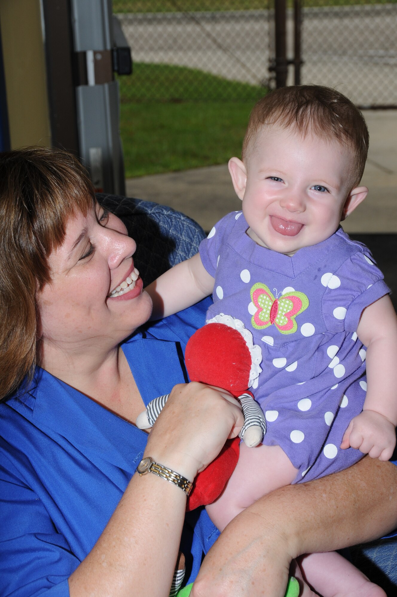 Keri Mueller, wife of Brig. Gen. Andrew Mueller, 81st Training Wing commander, 7-month-old Alexandra Boudreaux Monday at the child development center.  Alexandra's parents are Staff Sgt. Barry and Lindsey Boudreaux, 81st Training Support Squadron.  Mrs. Mueller volunteers on Mondays at the center. (U.S. Air Force photo by Kemberly Groue)