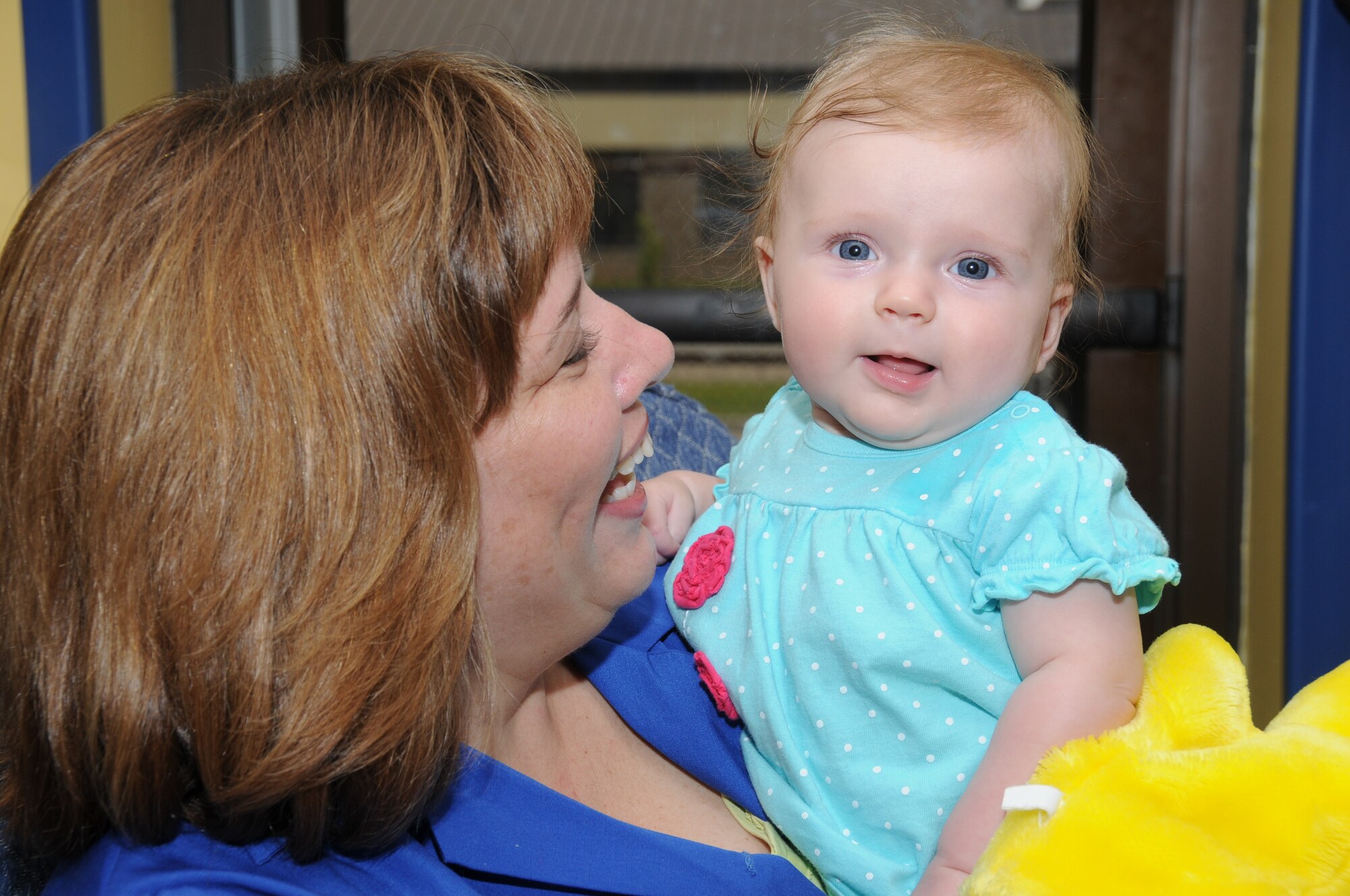 Keri Mueller, wife of Brig. Gen. Andrew Mueller, 81st Training Wing commander,
cuddles 4-monthold Mikayla Campbell Monday at the child development center. Mikayla’s parents are Staff Sgt. Adam Campbell, 85th Engineering Installation
Squadron, and Lisa Campbell, CSC marketing director.  Mrs. Mueller volunteers
on Mondays at the center. (U.S. Air Force photo by Kemberly Groue)