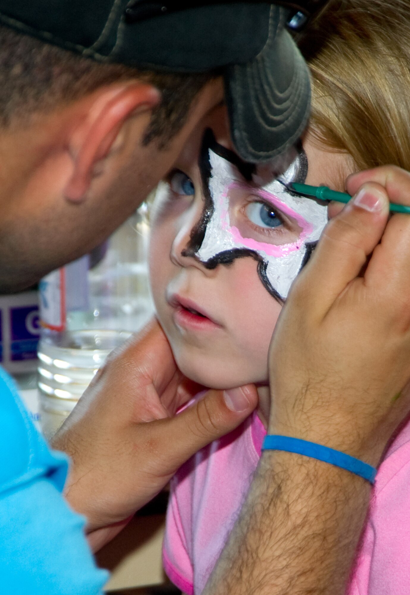 Around her bright, blue eyes, Bethany Estep, 9, has a star painted by Senior Airman Raul Macias, 81st Medical Operations Squadron. Bethany is the daughter of Staff Sgt. Bryan and Erica Estep, 403rd Wing.  (U.S. Air Force photo by Adam Bond)