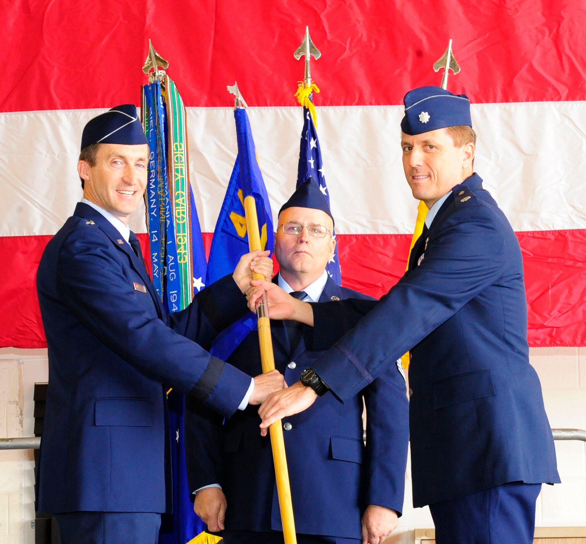 Lt. Col. Scott Crogg receives the guidon flag from Brig. Gen. Ronald Miller during the 44th Fighter Group assumption of command ceremony at Holloman Air Force Base, NM, April 3. Chief. Master Sgt. David Wood assists with the ceremonial tradition of passing the flag. (US Air Force photo by Senior Airman Martha Whipple)