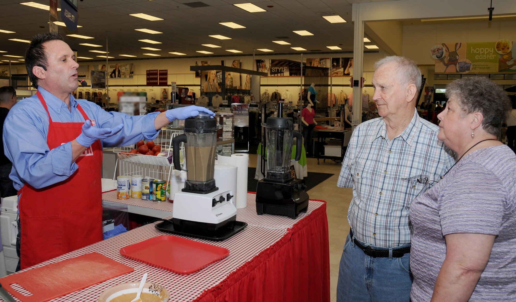 Vita-Mix representative Doug Cook, left, demonstrates equipment to Larry and Camille Pruitt of Long Beach at the one-year anniversary celebration at the main exchange.  Mr. Pruitt is a retired senior master sergeant.  (U.S. Air Force photo by Kemberly Groue)