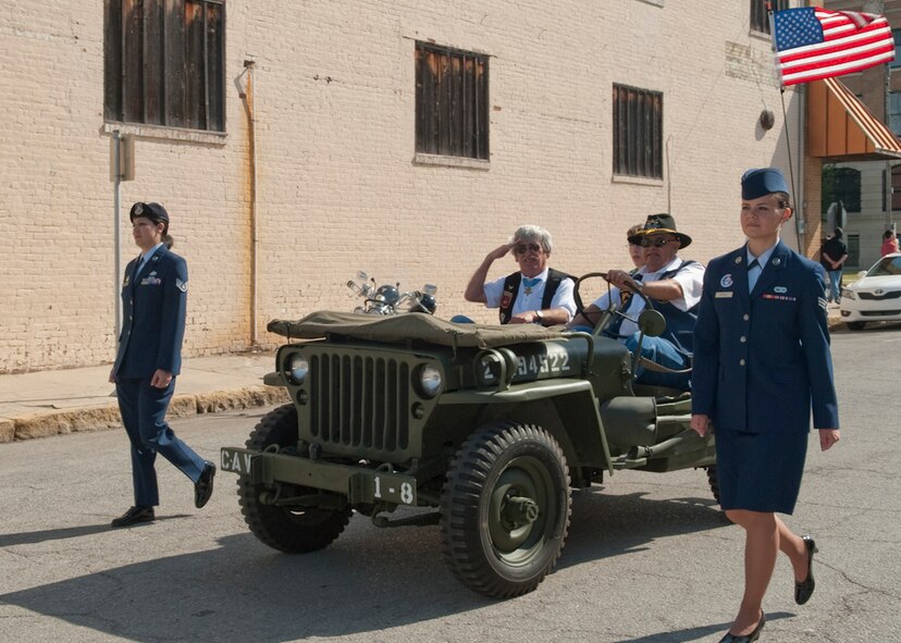 Former U.S. Marine Corps SGT Robert E. O'Malley, Vietnam Medal of Honor recipient salutes at the crowd of military service members during the annual MOH parade held at Gainesville, Texas, the Host City for MOH, April 9, 2011. He is escorted by members of the 136th Airlift Wing, Texas Air National Guard. His heroic act saved the lives of his wounded Marines by jumping into the trench, attacking the enemy with his rifle and grenades and singly killed eight of the them on August 18, 1965. (U.S. Air Force Photo by Senior Master Sgt. Elizabeth Giblert)
