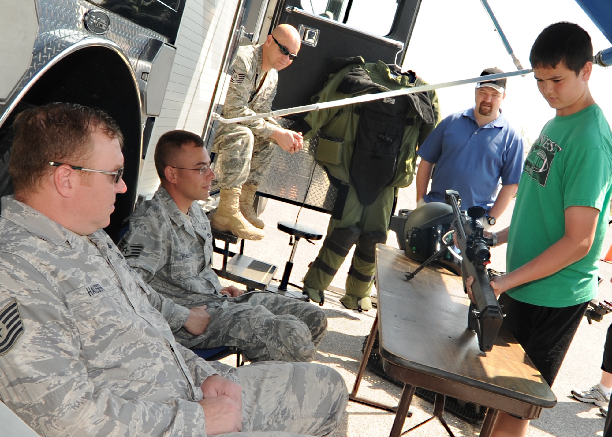 Jeff Fleming, Team McConnell family member, inspects a Barrett M107 sniper rifle at the explosive ordnance disposal van during the Family Festival of Fun April 9, 2011, McConnell Air Force Base, Kan. During the festival, different base organizations displayed their unit’s equipment and spoke about their mission to military families to help promote the “Month of the Military Child”. The festival offered family activities and games for children. (U.S. Air Force photo/Senior Airman Maria A. Ruiz)