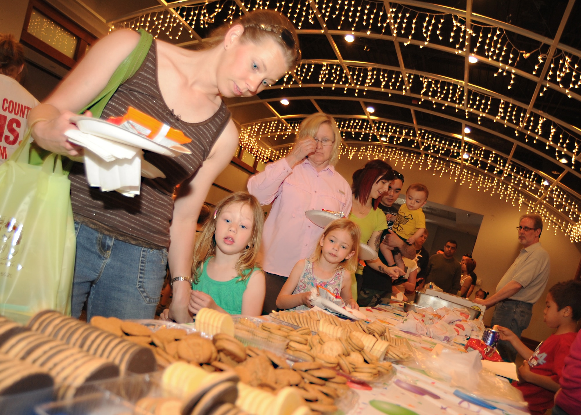 Team McConnell family members receive food during the Family Festival of Fun April 9, 2011, McConnell Air Force Base, Kan. The festival included fire truck rides, carnival games, snow cones and a free lunch. Team McConnell Airmen and their families gathered for the festival to celebrate the “Month of the Military Child.” (U.S. Air Force photo/Senior Airman Maria A. Ruiz)