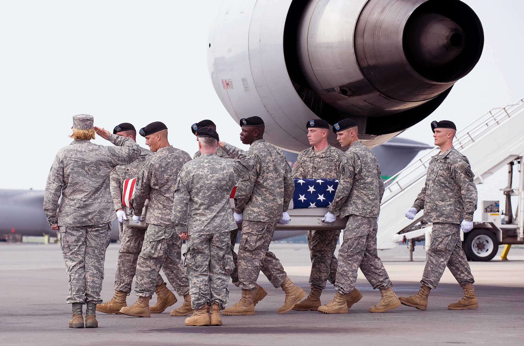 Col. Sharon Bannister and Army Maj. Gen. Merdith W. B. Temple salute as an Army carry team transfers the remains of Army Spc. Jamal M. Rhett Aug. 17, 2010, at Dover Air Force Base, Del. Colonel Bannister is one of nine colonels at Dover AFB who share the duty of calling the orders at dignified transfers honoring fallen servicemembers who return to U.S. soil. (U.S. Air Force photo/Jason Minto)
