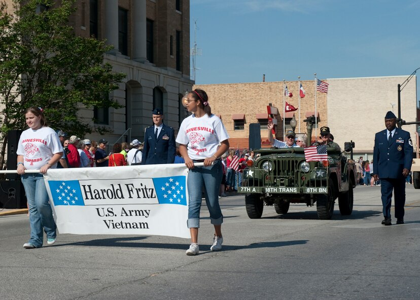 Army Lt. Col. (ret) Harold Fritz, Vietnam Medal of Honor recipient waves at the crowd during the annual MOH parade held at Gainesville, Texas, the Host City for MOH, April 9, 2011. He is escorted by members of the 136th Airlift Wing, Texas Air National Guard. His heroic act showed conspicuous leadership despite being seriously wounded during a firefight on Jan. 11, 1969 saving the lives of his Soldiers. (U.S. Air Force Photo by Tech Sgt. Charles Hatton)
