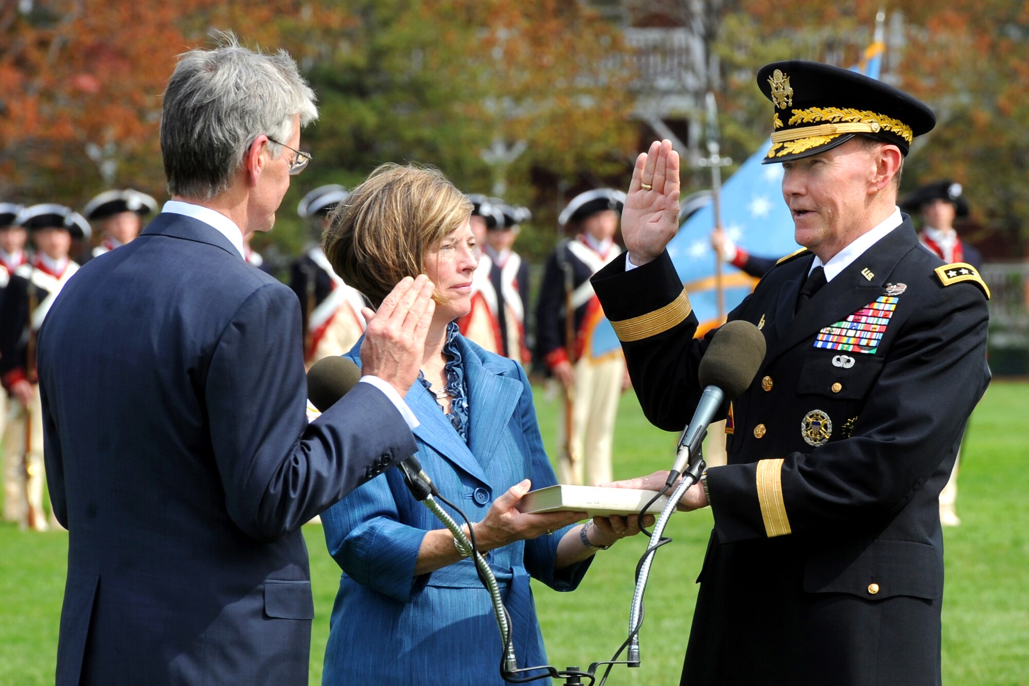 Army Secretary John M. McHugh delivers the oath of office to Army Gen. Martin E. Dempsey while his wife, Deanie looks on, during the swearing-in ceremony April 11, 2011, on Fort Myer, Va.  General Dempsey replaced Gen. George W. Casey Jr. as the Army chief of staff.  (Defense Department photo/Cherie Cullen)