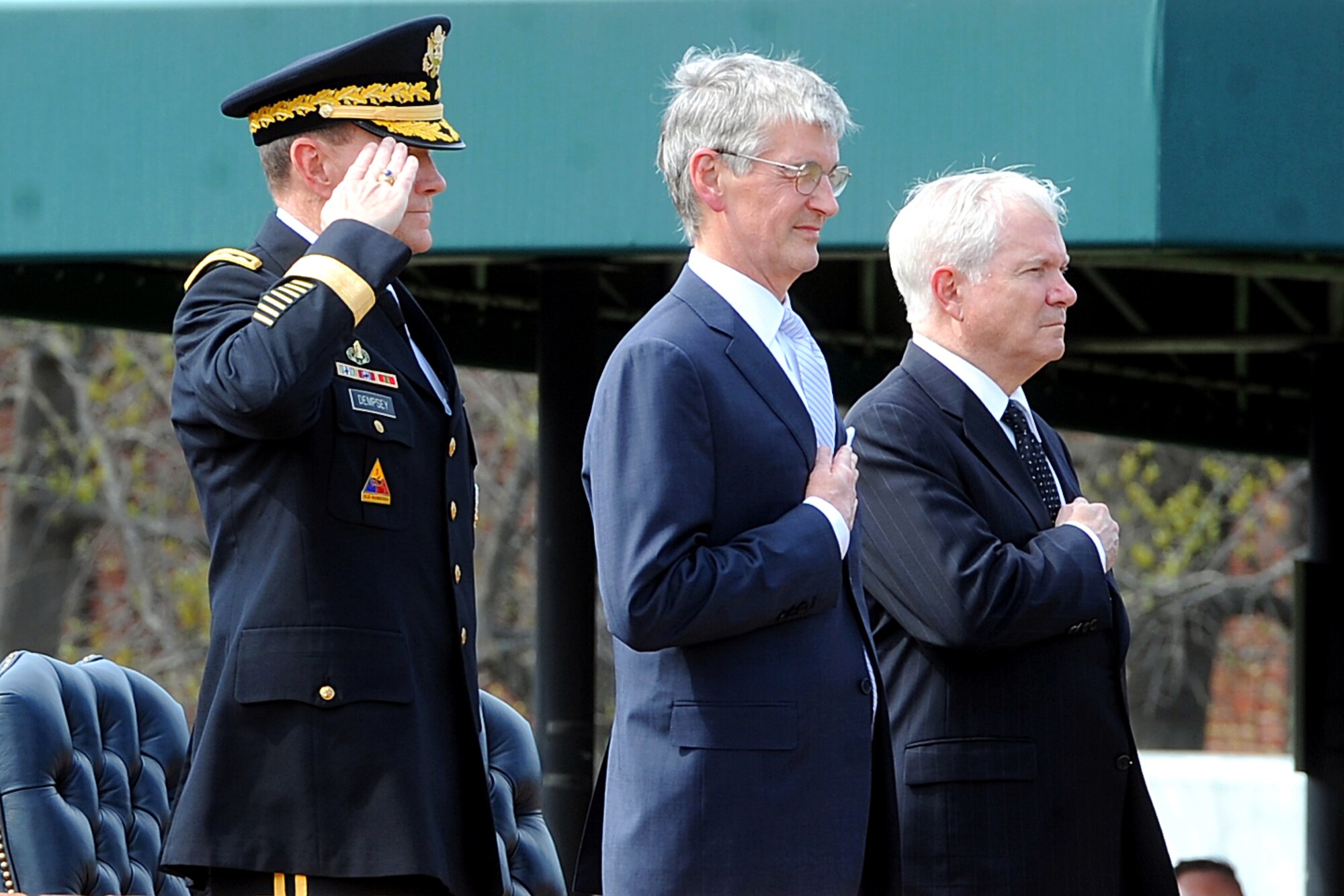 From left, Army Gen. Martin E. Dempsey, Army Secretary John M. McHugh and Defense Secretary Robert M. Gates render honors during the playing of the national anthem at the swearing-in ceremony for General Dempsey April 11, 2011, on Fort Myer, Va. General Dempsey replaced Gen. George W. Casey Jr. as the Army chief of staff.  (Defense Department photo/Cherie Cullen)