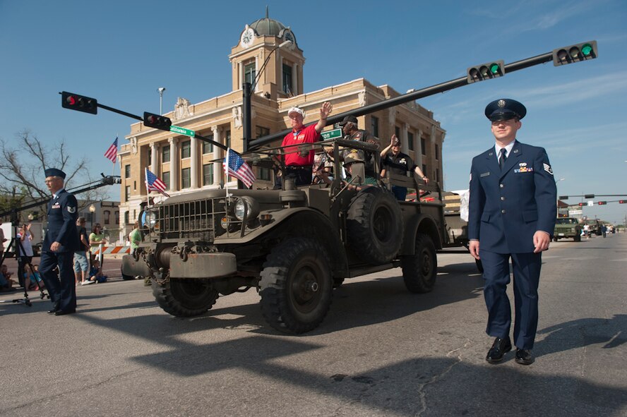 Army Major (ret) James A. Taylor, Vietnam Medal of Honor recipient waves at the crowd during the annual MOH parade held at Gainesville, Texas, the Host City for MOH, April 9, 2011. He is escorted by members of the 136th Airlift Wing, Texas Air National Guard. His heroic act contributed significantly to the success of the overall assault on the enemy position, and were directly responsible for saving the lives of a number of his fellow soldiers.(U.S. Air Force Photo by Tech Sgt. Charles Hatton)
