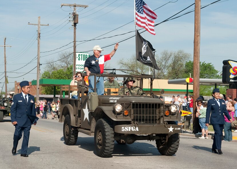 U.S. Marine Corps Col. (ret) Harvey 'Barney' C. Barnum, Vietnam Medal of Honor recipient waves at the crowd during the annual MOH parade held at Gainesville, Texas, the Host City for MOH, April 9, 2011. He is escorted by members of the 136th Airlift Wing, Texas Air National Guard. His gallant initiative and heroic conduct saved the lives of his men on Dec. 18, 1965. (U.S. Air Force Photo by Senior Master Sgt. Elizabeth Giblert)
