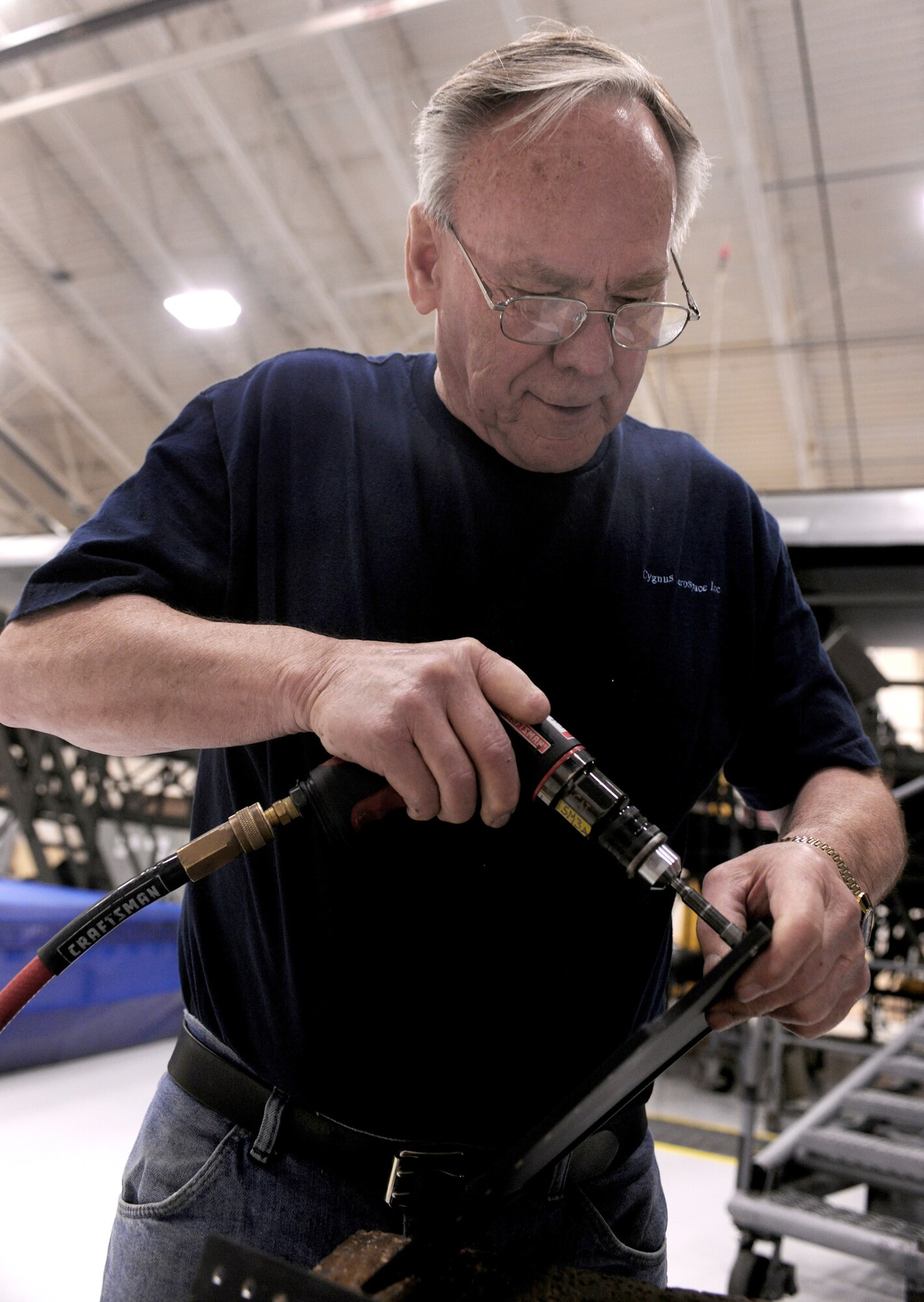 Richard Bradshaw, an aircraft structural technician, smoothes a metal component during installation of a loadmaster crashworthy seat April 7, 2011, at Moody Air Force Base, Ga. Aircraft engineers and technicians there are currently engineering the first loadmaster crashworthy seat in Air Combat Command to be trial tested in an HC-130P Combat King. (U.S. Air Force photo/Airman 1st Class Benjamin Wiseman)