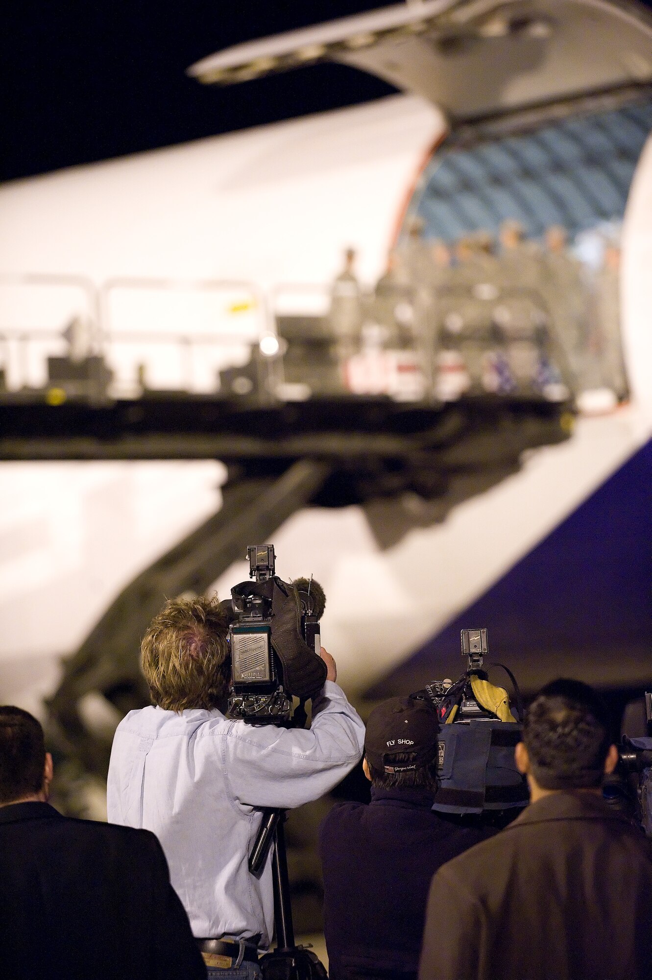 Media attend a dignified transfer on April 6, 2009 after implementation of Secretary of Defense policy allowing media to attend dignified transfers if the family chooses to allow media presence.