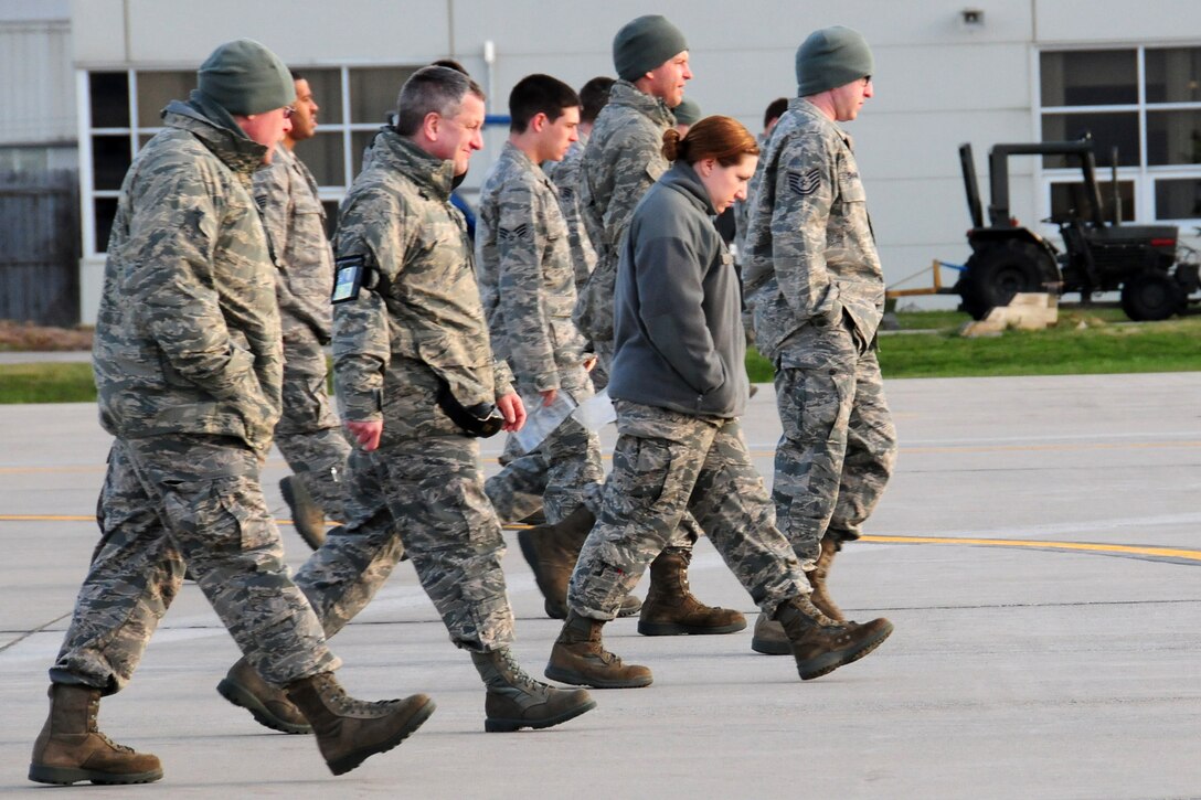 NIAGARA FALLS AIR RESERVE STATION, N.Y-  Members of the 914th (Air Force Reserve) and 107th Airlift Wing (New York Air National Guard), Niagara Falls ARS perform a weekly Foreign Object Debris (FOD) walk.  Typically this function is performed by maintenance and safety personnel, but it is everyone's responsibility to pick up any debris found while on the flight line.  This week a base wide announcement was made to invite all unit members to participate.  (U.S. Air Force Reserve photo by Peter Borys)