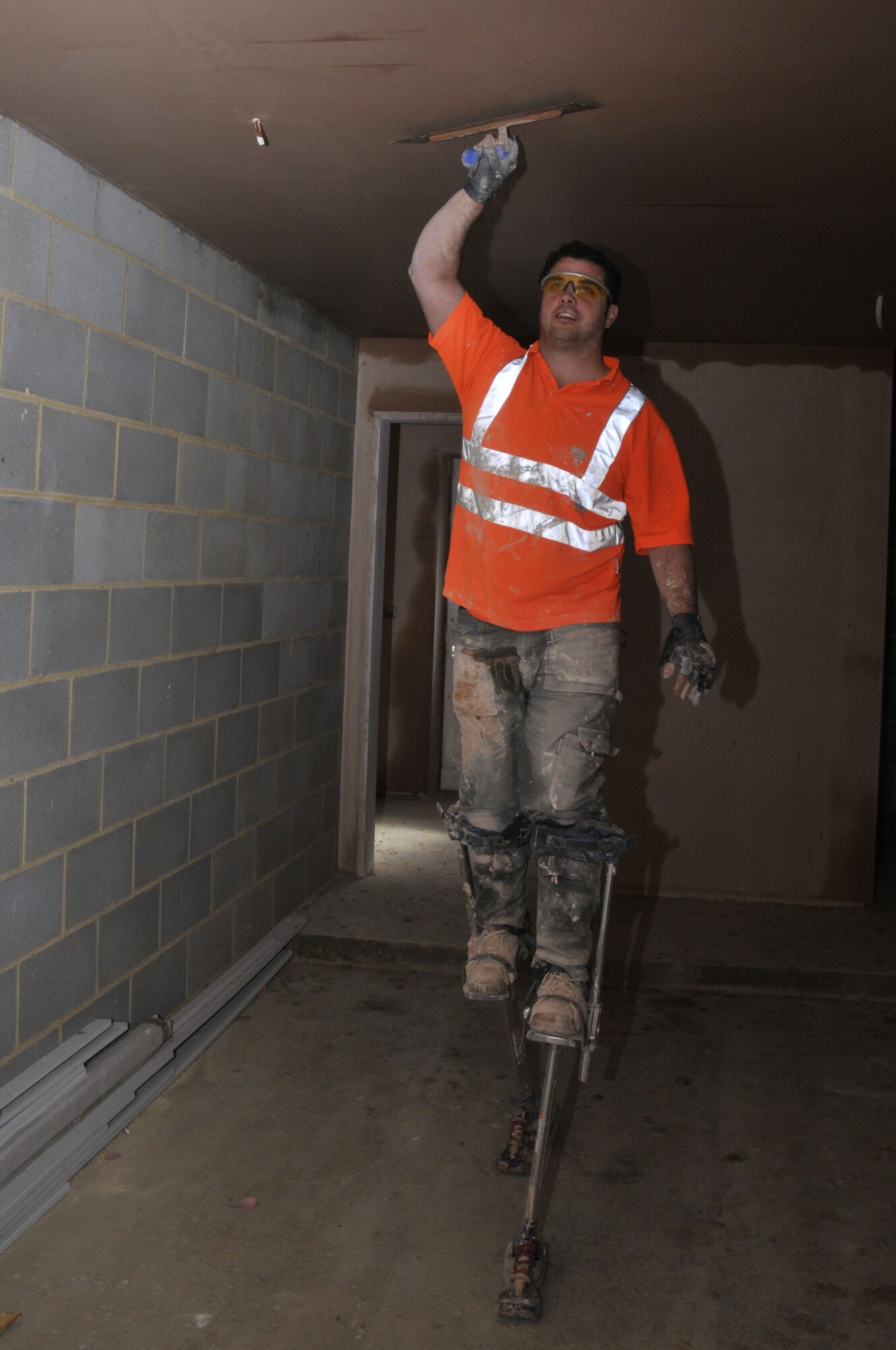 ROYAL AIR FORCE, LAKENHEATH, England -- Stacey Polombo, Mansell construction worker, plasters the ceiling of a garage on April 6, 2011. The construction of Liberty Village with 606 homes started in 2005 is due to be finished this November. (U.S. Air Force photo/Senior Airman Eboni Reams) 

