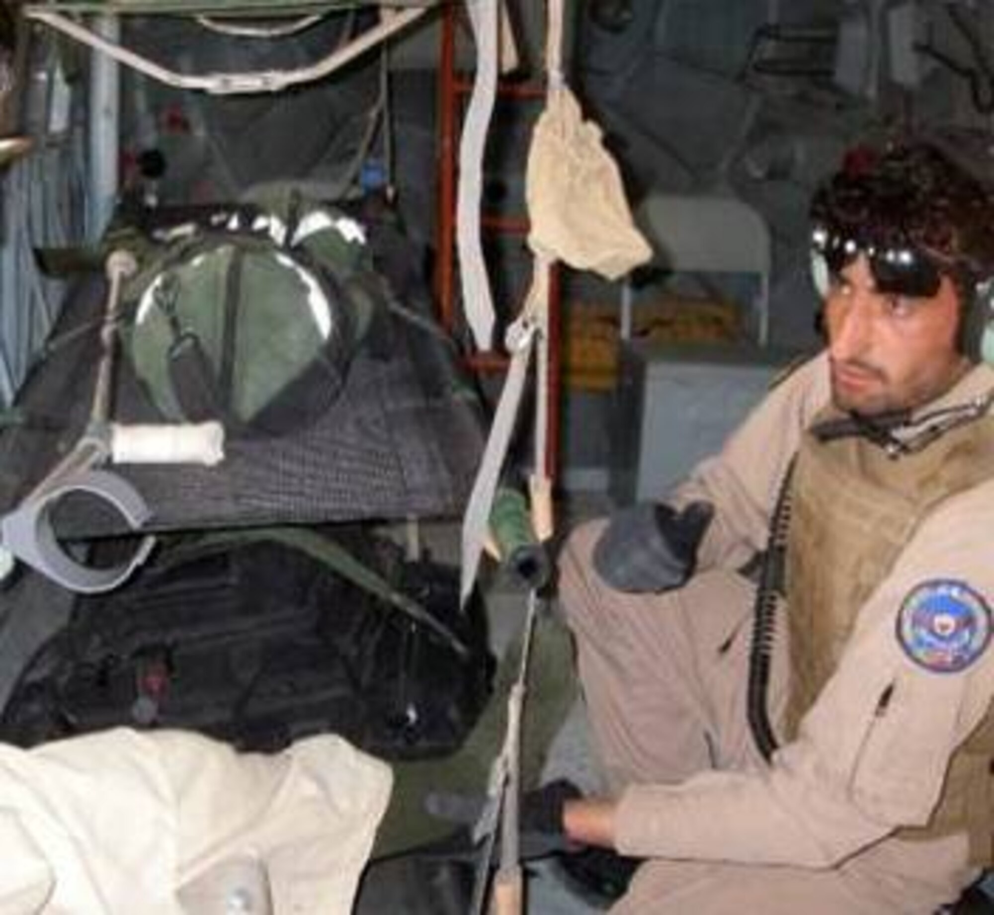 4/11/2011 - KANDAHAR, Afghanistan – Afghan Flight Medic Fazal, completes the neurologic and circulatory assessment of his patient during a medical evacuation flight from Camp Bastion to Kandahar.  The evacuation was the first-ever dedicated Mi-17 medical evacuation mission flown from Kandahar Air Wing and was a big step in supporting the requirements of the Afghan National Army.  (U.S. Air Force Courtesy Photo)