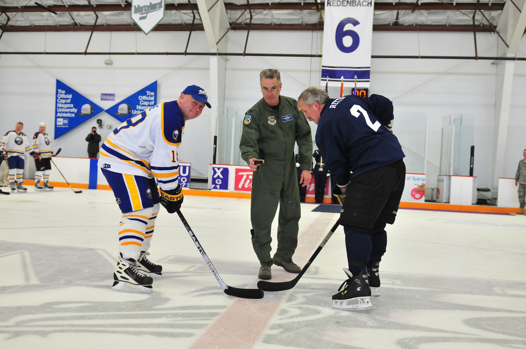 Colonel Jim McCready Commander of the 107th Airlift Wings drops the official puck to start off the Buffalo Sabers?  Alumni against Niagara Falls Air Reserves Stations Team Niagara game on April 10, 20011. Sabers Danny Gare faces off with Air Force Reserve John Rettig.(Air Force Photo/TSgt Justin Huett)