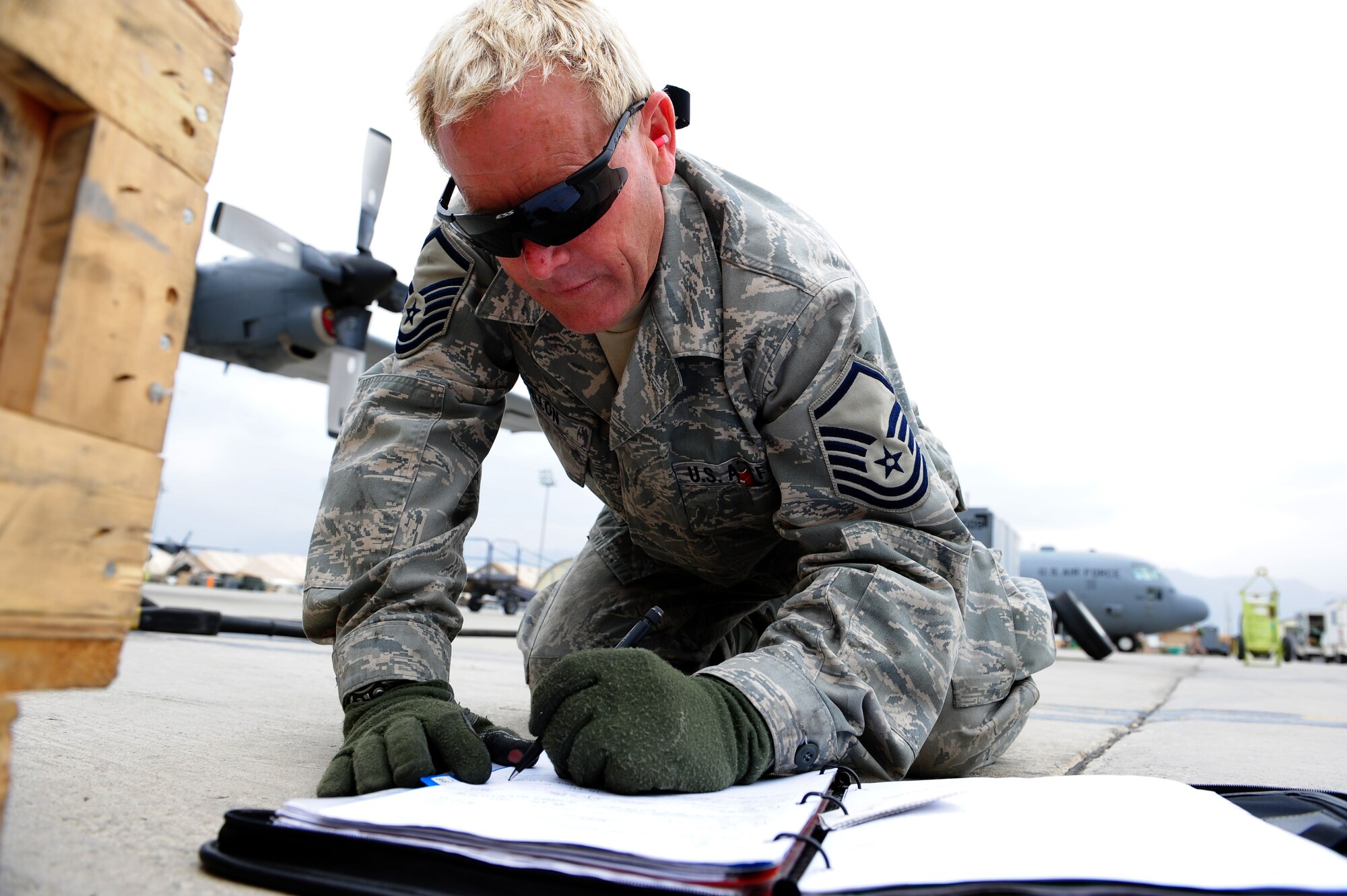 U.S. Air Force Master Sgt. Jeff Dillon, 455th Expeditionary Aircraft Maintenance Squadron crew chief, fills out the repair log after changing out the front tires for a C-130 Hercules aircraft at Bagram Airfield, Afghanistan, April 9, 2011. Dillon is deployed from the Delaware Air National Guard’s 166th Aircraft Maintenance Squadron, New Castle, Del., supporting Operation Enduring Freedom. (U.S. Air Force photo/Master Sgt. William Greer)