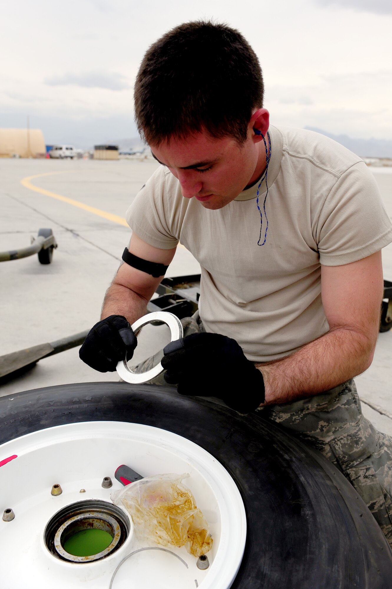 U.S. Air Force Senior Airman Kevin Perry, 455th Expeditionary Aircraft Maintenance Squadron crew chief, prepares a new tire to be installed on a C-130 Hercules aircraft at Bagram Airfield, Afghanistan, April 9, 2011. Perry is deployed from the Delaware Air National Guard’s 166th Aircraft Maintenance Squadron, New Castle, Del., supporting Operation Enduring Freedom. (U.S. Air Force photo/Master Sgt. William Greer)