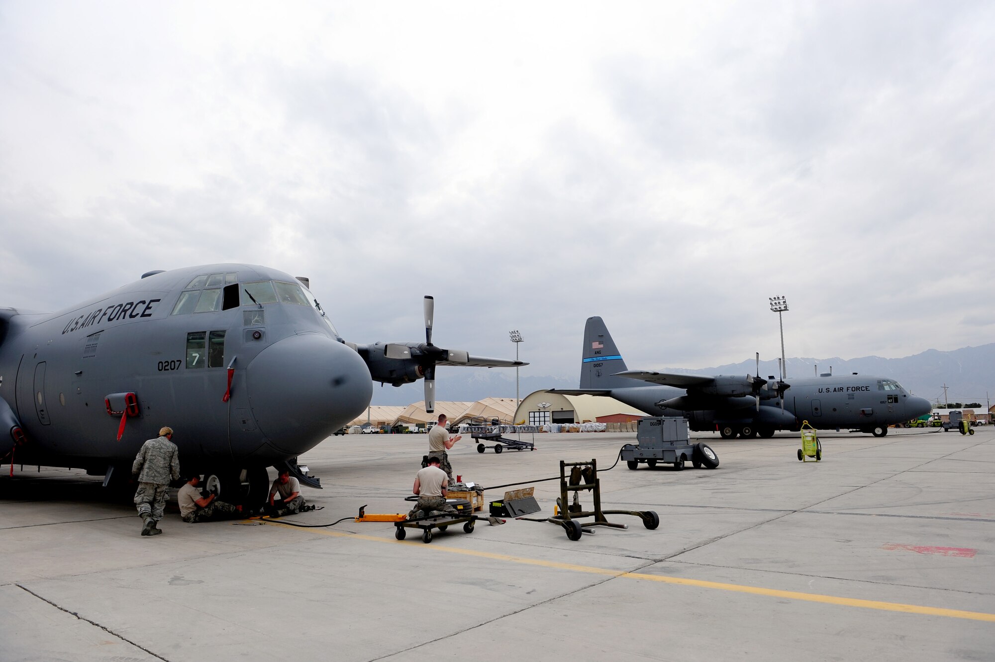 U.S. Air Force crew chiefs, from the 455th Expeditionary Aircraft Maintenance Squadron, change out the front tires on a C-130 Hercules aircraft at Bagram Airfield, Afghanistan, April 9, 2011.  The Airmen are deployed from the Delaware Air National Guard’s 166th Aircraft Maintenance Squadron, New Castle, Del., supporting Operation Enduring Freedom. (U.S. Air Force photo/Master Sgt. William Greer)