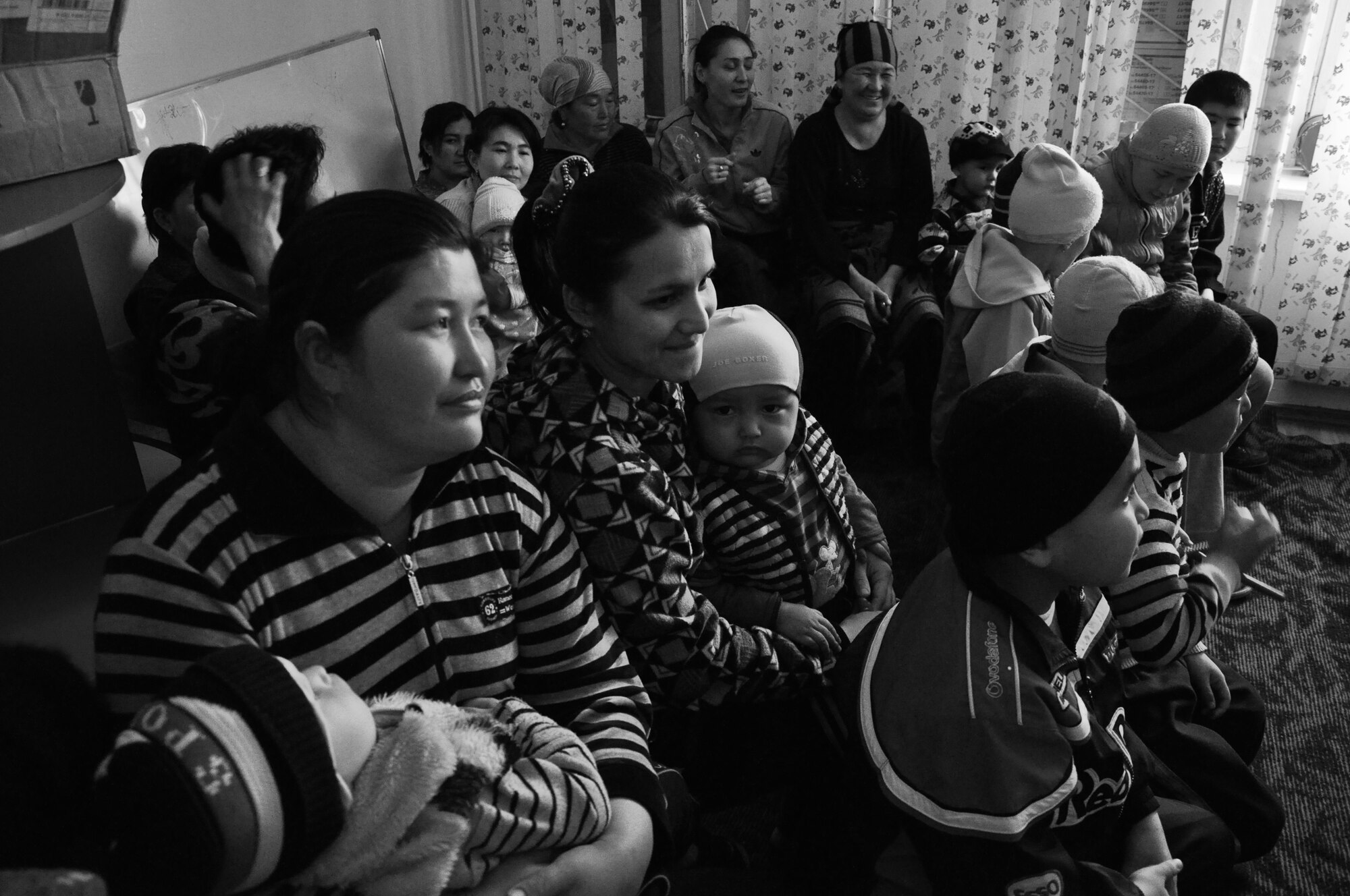 Parents & staff members of the Children's Cancer Center in Bishkek, Kyrgyzstan enjoy the AFCENT Band Wild Blue Country's performance.  Members of the 376 AEW Medical Group, Tranist Center at Manas accompanied the band during their visit. (U.S. Air Force photo by Master Sgt. Daniel Nathaniel III)