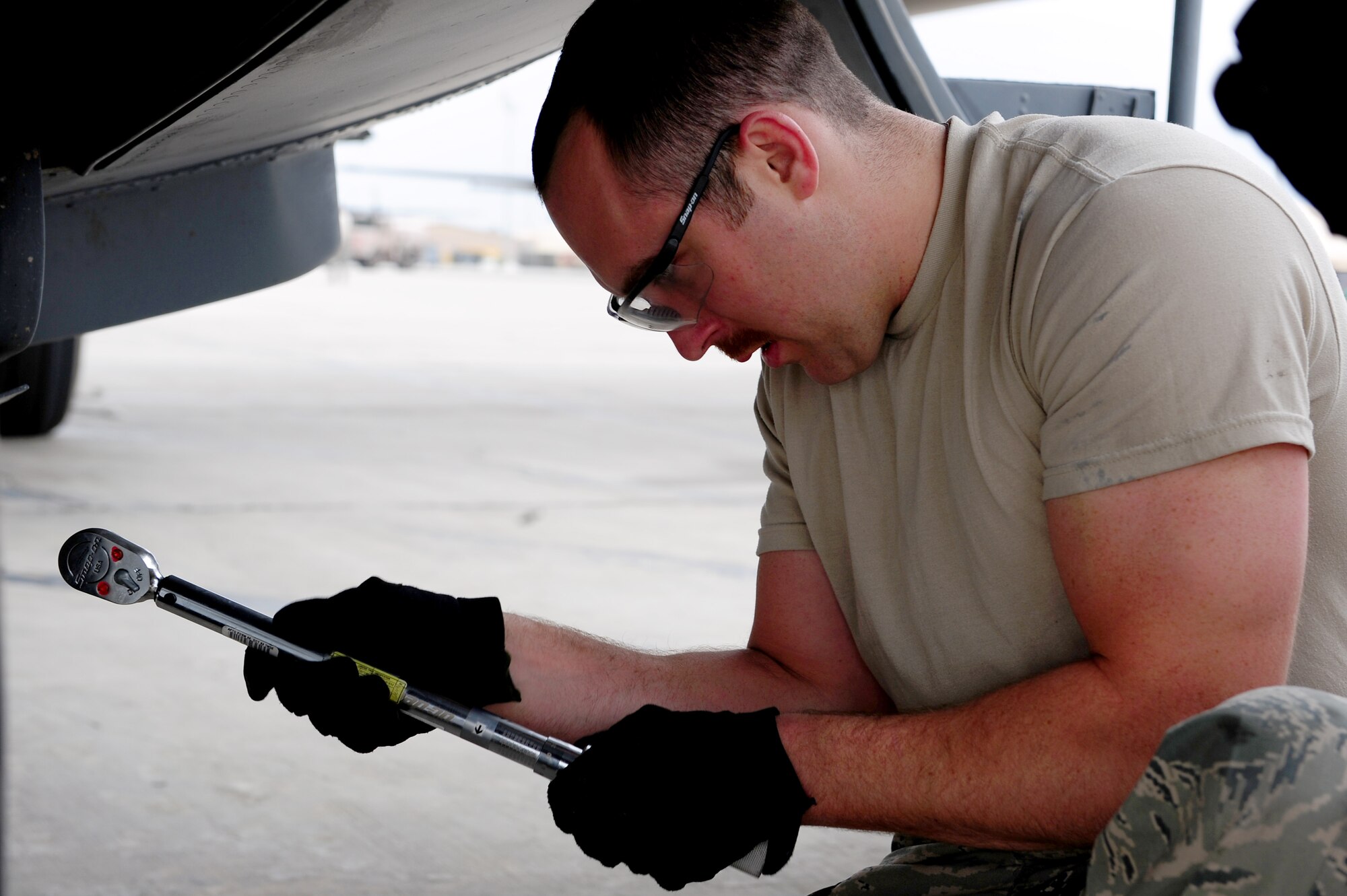 U.S. Air Force Staff Sgt. Justin Greenhow, 455th Expeditionary Aircraft Maintenance Squadron crew chief, checks the settings on his torque wrench during a tire change procedure on a C-130 Hercules aircraft at Bagram Airfield, Afghanistan, April 9, 2011. Greenhow is deployed from the Delaware Air National Guard’s 166th Aircraft Maintenance Squadron, New Castle, Del., supporting Operation Enduring Freedom. (U.S. Air Force photo/Master Sgt. William Greer)