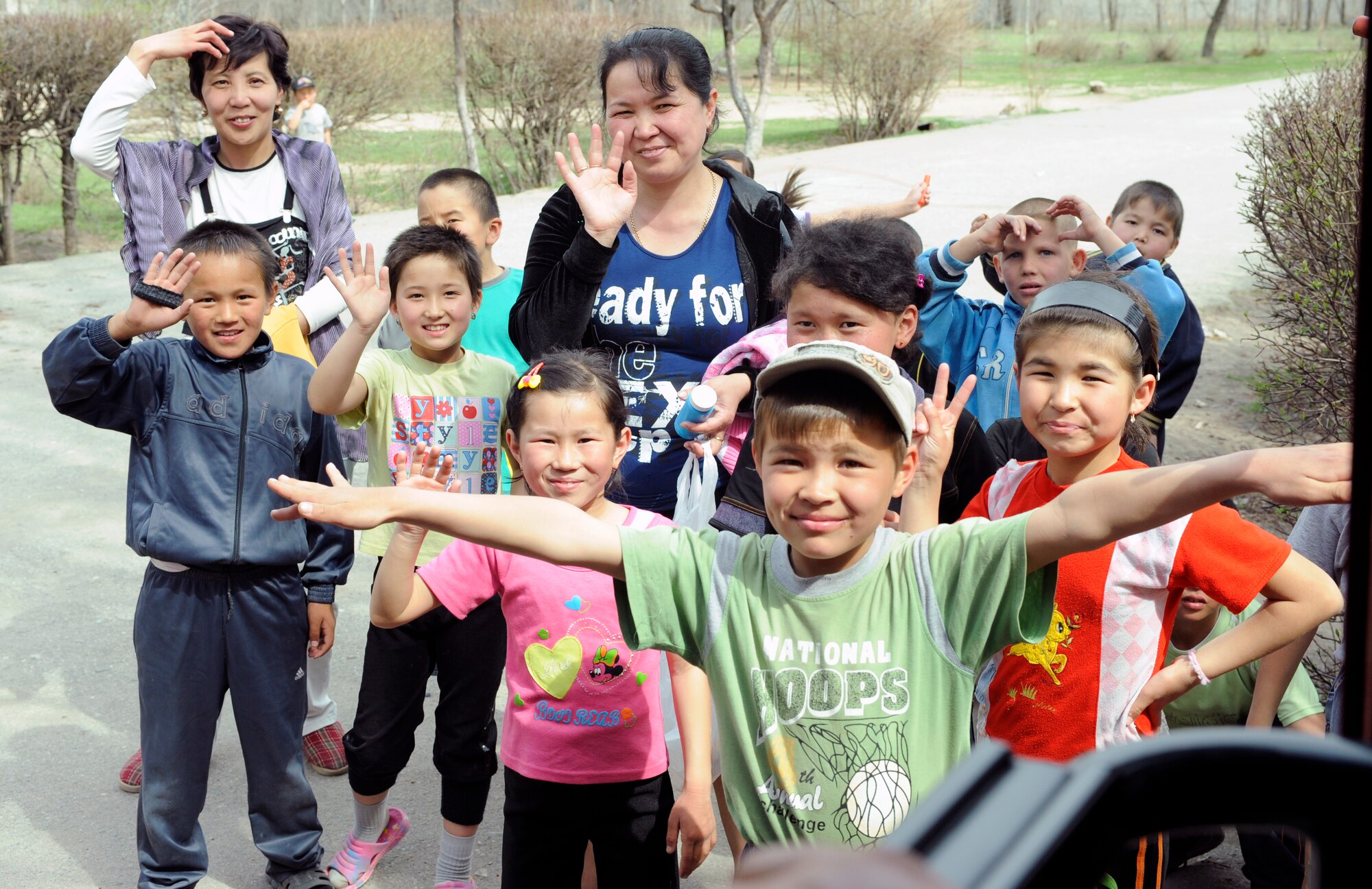 NIZNE-CHUISK VILLAGE, Kyrgyzstan - Schoolteachers and children say their goodbyes at the village orphanage here Monday.  Manas Area Benefit Outreach Society reps visited the village to donate items and their time for games and laughter with the local youth.  (U.S. Air Force photo/Tech. Sgt. Jerome C. Baysmore) 
