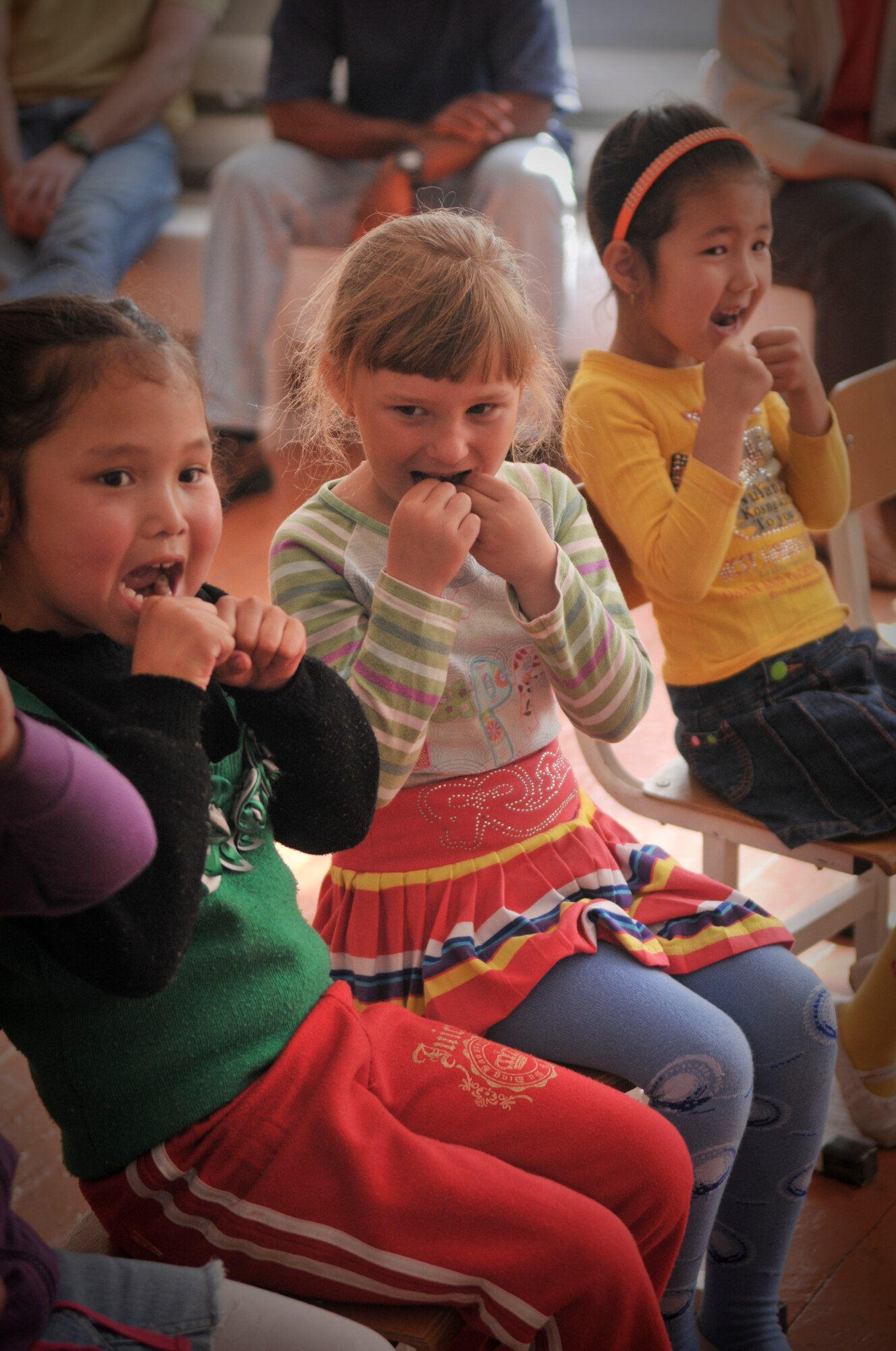TRANSIT CENTER AT MANAS, Kyrgyzstan  - Members from the Transit Center at Manas meet with children from the Vasilievka school in Vasilievka village  as a part of a Dental outreach mission April 12.  Dental personnel demonstrated the correct way to brush and floss, what kinds of foods are good or bad for teeth and even played a few fun games designed to teach them about teeth. They also donated 90 kits with floss, toothpaste, and tooth brushes, the Civil Air Patrol also donated over 900 dollars and 50 pounds worth of toys and supplies to the school. (U.S. Air Force photo/Staff Sgt. Stacy Moless)


