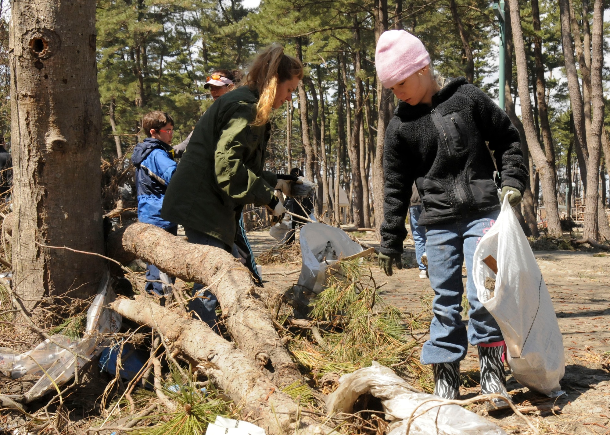 MISAWA AIR BASE, Japan -- Anyka Perzynski-Drilling, 8, and her mom, Lindsey Drilling, search for debris at a park in Hachinohe, Japan, April 12. Ms. Drilling had volunteered with Misawa Helps before and said she thought it was important to get the children involved as well. (U.S. Air Force photo by Staff Sgt. Rachel Martinez/Released)