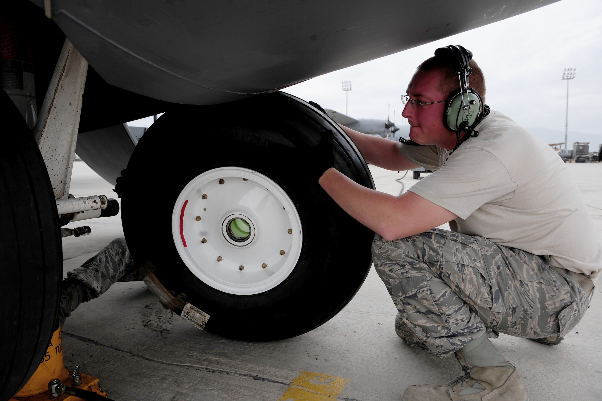 U.S. Air Force Staff Sgt. John Green, 455th Expeditionary Aircraft Maintenance Squadron crew chief, maneuvers a fresh tire into position during a tire change procedure on a C-130 Hercules aircraft at Bagram Airfield, Afghanistan, April 9, 2011. Green is deployed from the Delaware Air National Guard’s 166th Aircraft Maintenance Squadron, New Castle, Del., supporting Operation Enduring Freedom. (U.S. Air Force photo/Master Sgt. William Greer)