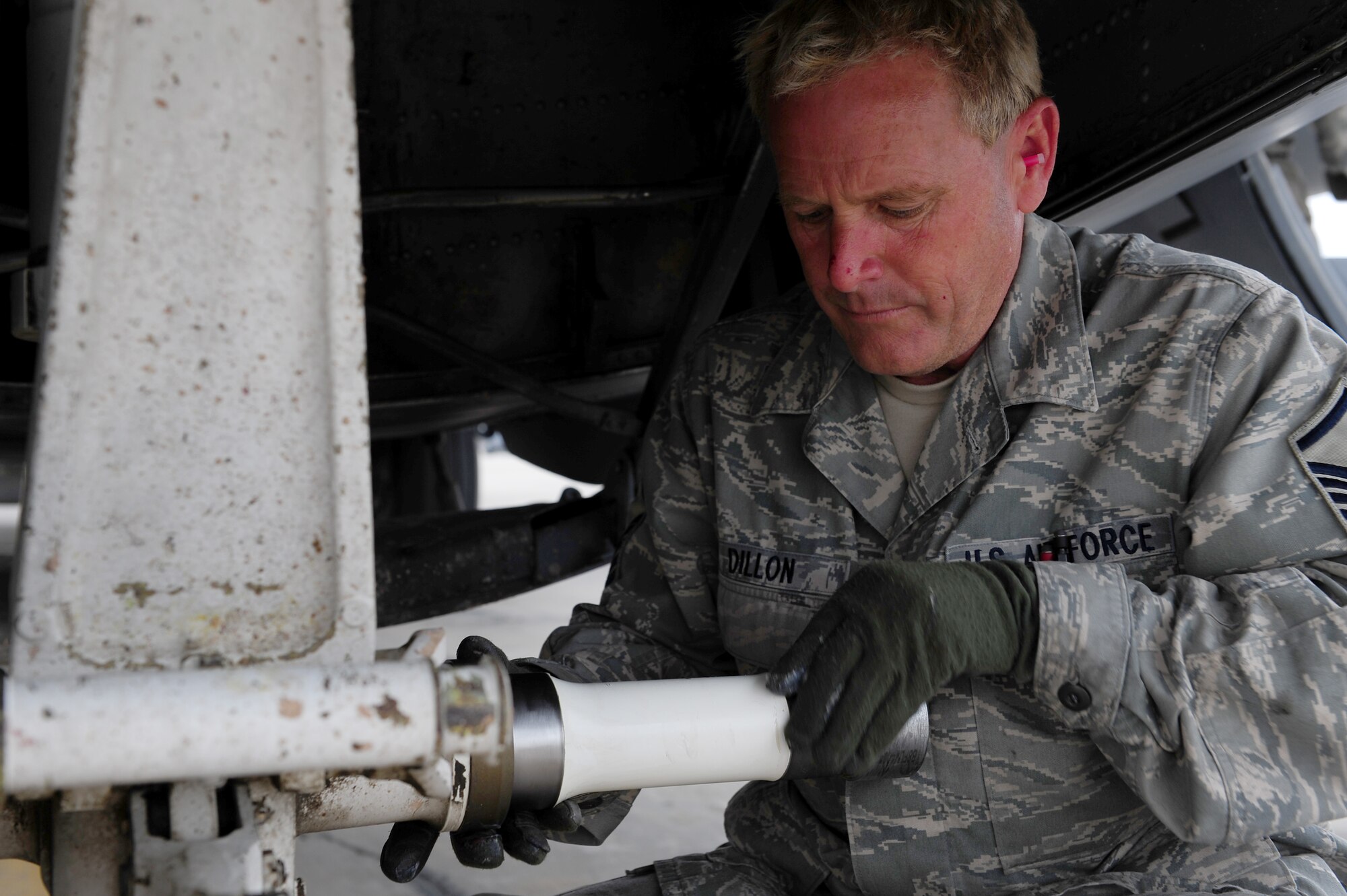 U.S. Air Force Master Sgt. Jeff Dillon, 455th Expeditionary Aircraft Maintenance Squadron crew chief, applies grease to the axel a C-130 Hercules nose landing gear assembly during a tire change procedure at Bagram Airfield, Afghanistan, April 9, 2011. Dillon is deployed from the Delaware Air National Guard’s 166th Aircraft Maintenance Squadron, New Castle, Del., supporting Operation Enduring Freedom. (U.S. Air Force photo/Master Sgt. William Greer)