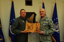 Gen. Gary North, Pacific Air Forces commander, (left) is awarded the "Order
of the Sword" and presented with a plaque by Chief Master Sgt Brooke McLean,
PACAF command chief, April 4, 2011, at Joint Base Pearl Harbor-Hickam, Hawaii. The "Order of the Sword", patterned after orders of chivalry founded during the Middle Ages in Europe, is presented by the enlisted corps and is the highest honor awarded to officers. Through the ages, noncommissioned officers have honored their
leaders and pledged loyalty to them by ceremoniously presenting them with a
sword that served as a token for all to see and know that here was a leader
amongst leaders and a man amongst men. Enlisted men and women of PACAF have
scheduled the ceremony and banquet Aug. 26, 2011. (U.S. Air Force
photo/Master Sgt. Victoria Meyer)