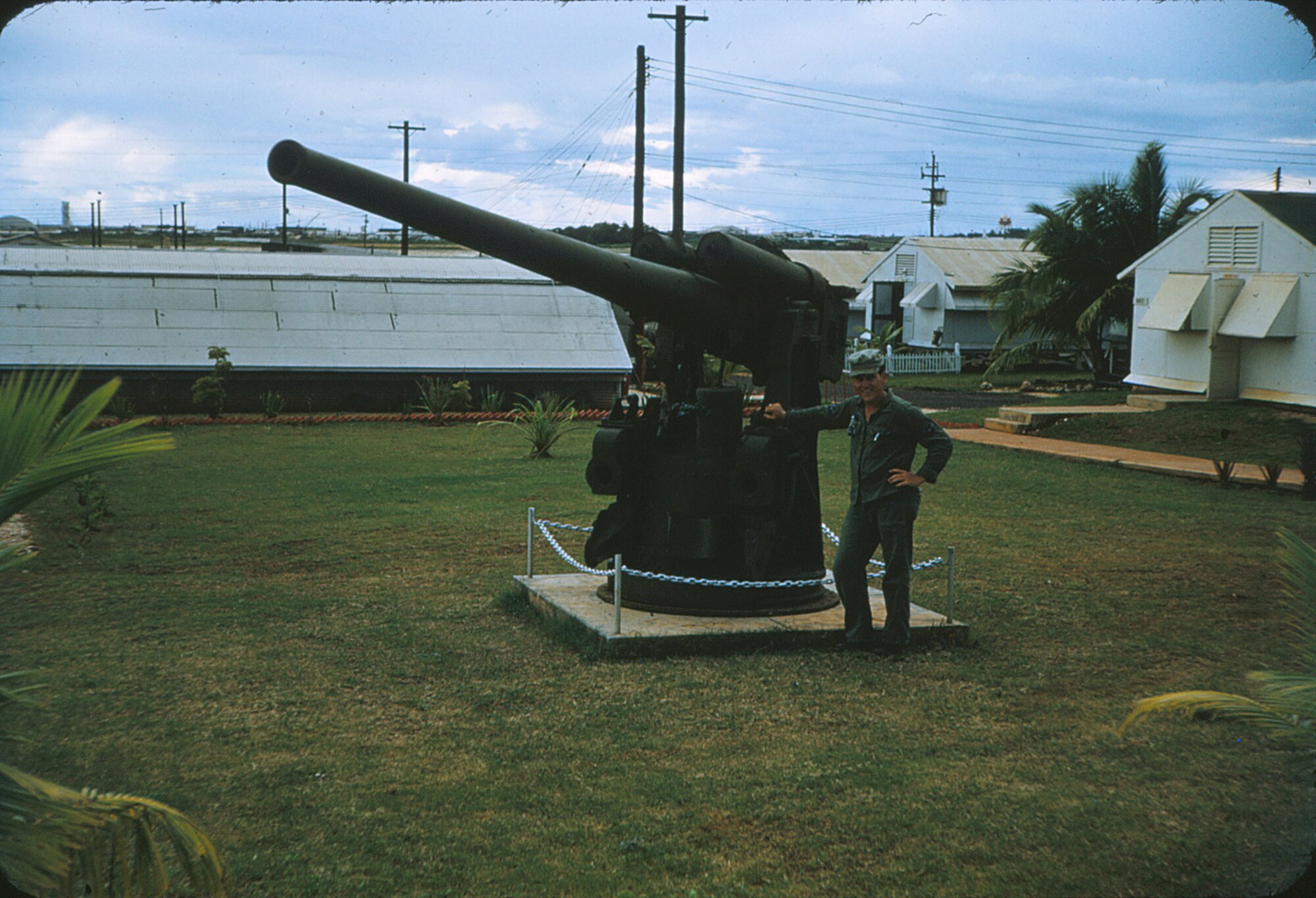 Eldred Pearson, an Air Force veteran, shares photos of his past during a visit here April 11. Stationed on Andersen from 1954-1956 as a member of the 3rd Aviation Support Depot working with munitions, Mr. Pearson poses next to a Japanese Naval  monument.(Courtesy photo)