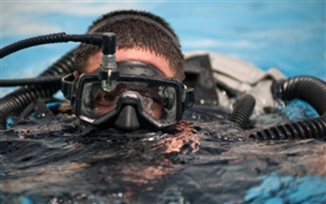U.S. Navy Petty Officer 2nd Class Alan Dewitt, assigned to Mobile Diving and Salvage Unit 2, performs a training dive to familiarize himself with the MK 16 MOD 1 underwater breathing apparatus at Naval Support Activity Bahrain on March 23, 2011.  The Mark 16 is a re-breathable underwater system used for bubble-free operations in water conditions with low visibility.  Personnel from Mobile Diving and Salvage Unit 2 are assigned to Combined Joint Task Force 56.1, which provides maritime security operations and theater security cooperation efforts in the U.S. 5th Fleet area of responsibility.  