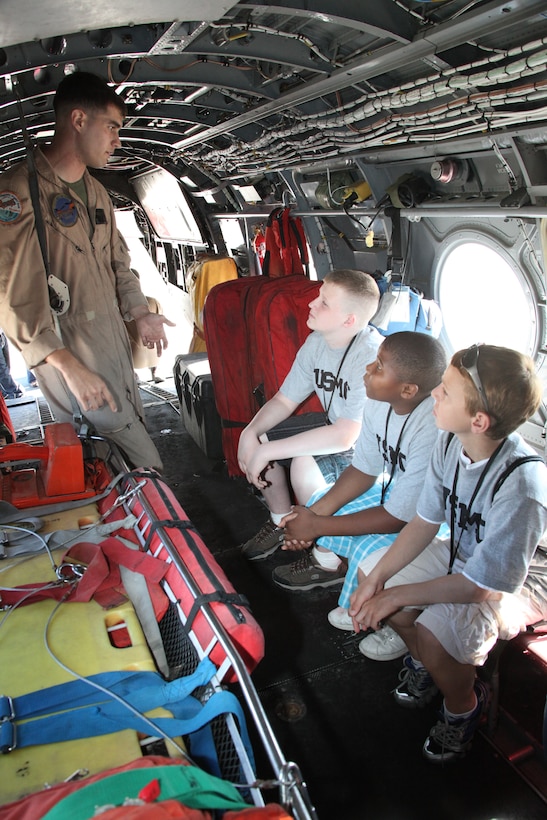 Cpl. Bruce D. Barner, a crew chief with Marine Transport Squadron 1, explains to teenagers how VMR-1 operates from its HH-46Es during the Teen All-Access Tour aboard Cherry Point April 14. VMR-1, or “Pedro,” is often called to conduct rescues off of the North Carolina coast.