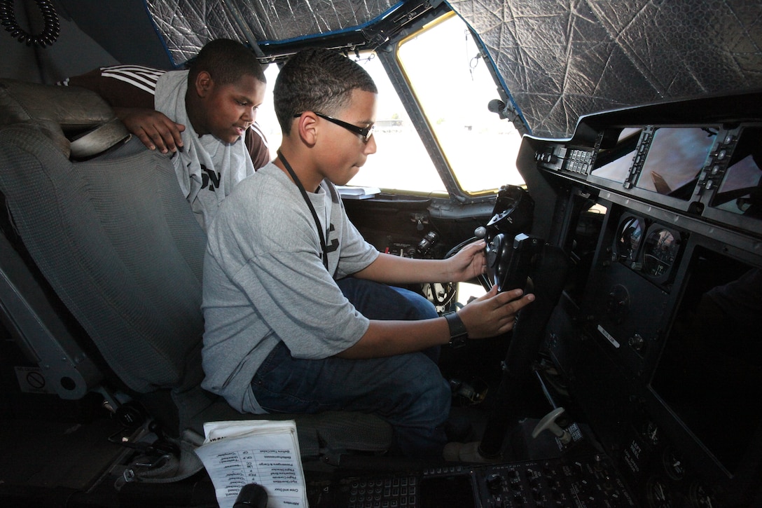 Brennen Smith, front, and Emanuel Villegas, both 13, examine the controls of a KC-130J outside Marine Aerial Refueler Transport Squadron 252’s hangar during the Teen All- Access Tour aboard Cherry Point April 14. By touring the aircraft inside and out, the teens learned about its capabilities and what life is like for the pilots and crew during a mission.
