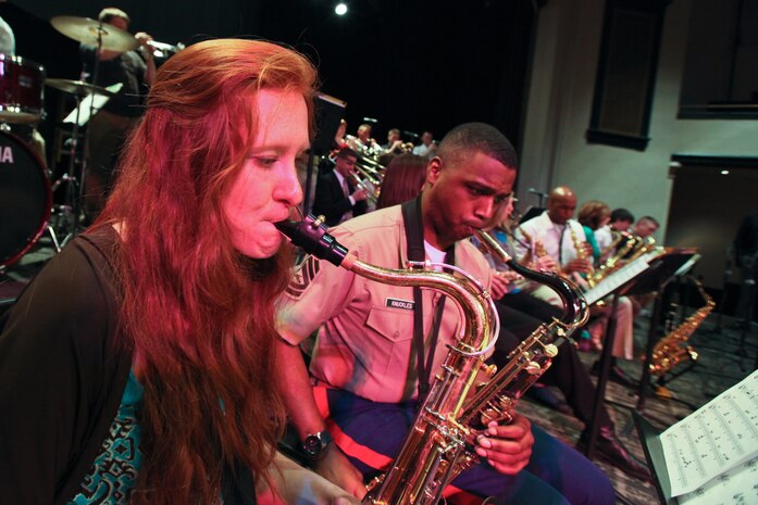 Gunnery Sgt. Jason Knuckles, a tenor saxophonist in the Marine Corps All Star Jazz Band, plays with a band student at Marquette High School, Marquette, Mich., during a clinic April 14, 2011. The All Star Jazz Band is made up of the best 18 Marine jazz musicians, chosen through a audition based selection process, and tours to increase recruiting in the specific Marine Corps District they perform in. The band holds concerts and clinics at high schools and colleges as they travel.