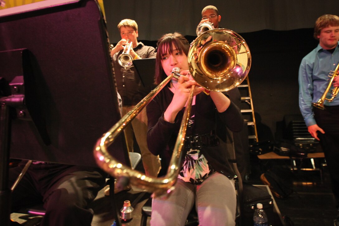 Students of the Marquette High School band play along side the Marine All Star Jazz Band in Marquette, Mich., April 14, 2011. Marine musicians from the 12 field bands auditioned to be a part of the all star jazz band and 18 were chosen to be a part of the recruiting tour across Michigan. The band performed at concerts and held clinics at high schools and colleges throughout Michigan during the recruiting tour.
