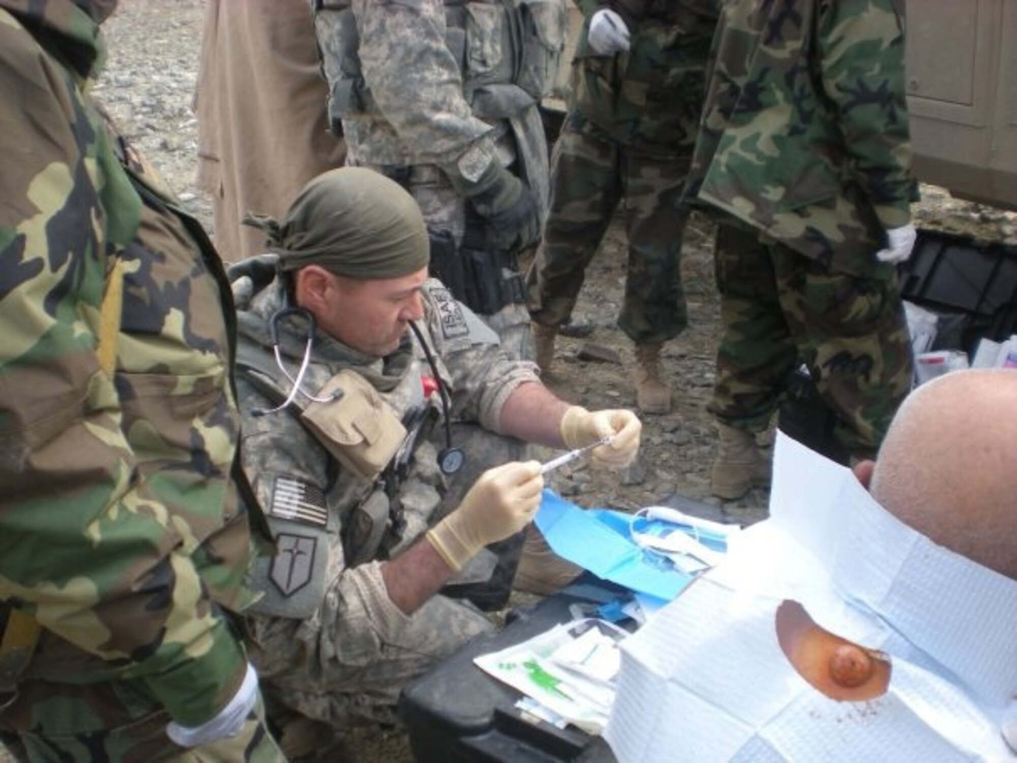 Capt. Jon Farley treats a patient and mentors his Afghan counterpart May 20, 2009, while assigned to Combined Joint Task Force 101, Alasai Valley, Kapisa Province, Afghanistan. Captain Farley is a physician's assistant assigned to the 354th Medical Operations Squadron, Eielson Air Force Base, Alaska. (U.S. Air Force photo/Chief Master Sgt. John Zincone) 