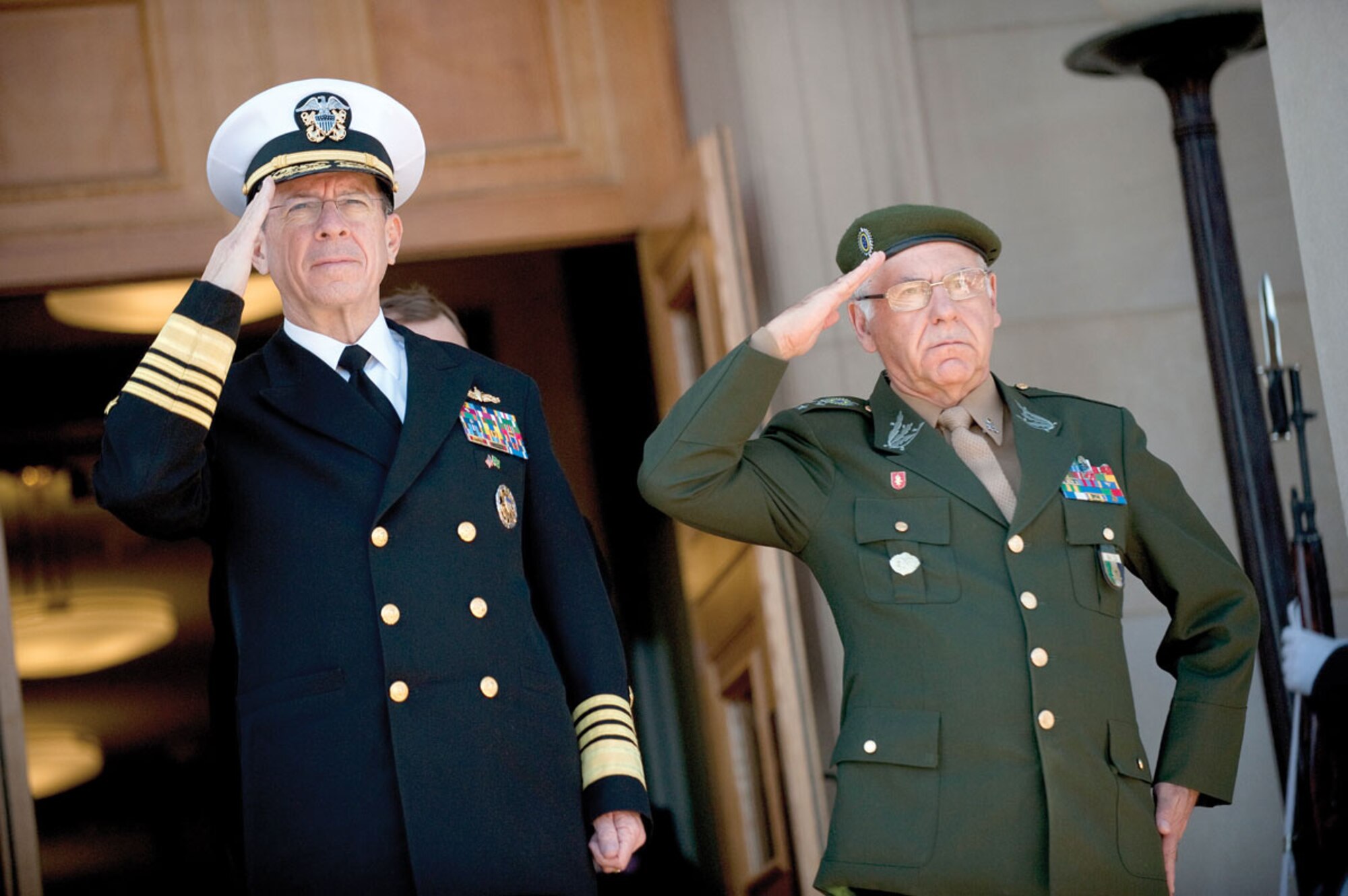 Chairman of the Joint Chiefs of Staff Navy Adm. Mike Mullen and Brazilian Gen. Jose Carlos de Nardi salute during the playing of their national anthems, March 7. Customs and courtesies are important in any military. (Photo by Navy Petty Officer 1st Class Chad J. McNeeley)