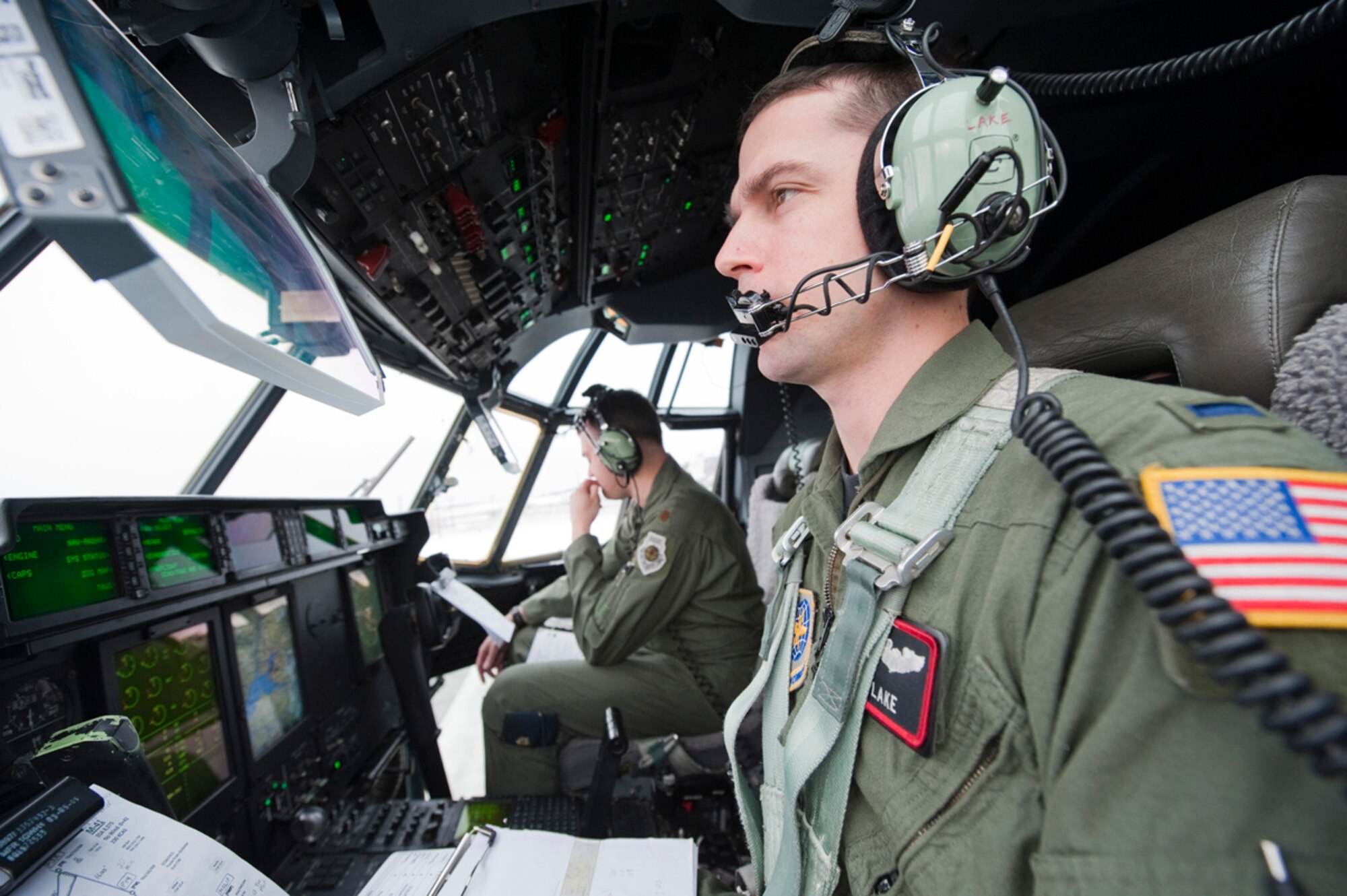 JOINT BASE ELMENDORF-RICHARDSON, Alaska - Air Force Lt. Seth Lake, 41st Airlift Squadron, right and Maj. Joseph Framptom, 19th Airlift Wing, go through their pre-flight checklist  April 4. Their C-130 J Model was from the 19th AW, Little Rock Air Force Base, Arkansas. This They were preparing for a heavy drop and personnel drop performed with the 3rd Battalion, 377th Parachute Field Artillery Regiment. (U.S. Air Force photo/Senior Airman Christopher Gross)  
