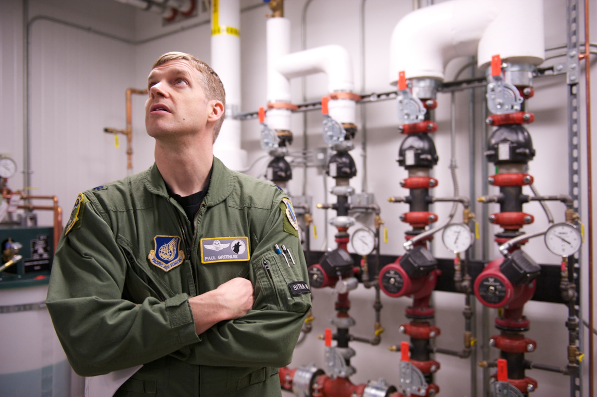 JOINT BASE ELMENDORF-RICHARDSON, Alaska -- Air Force Lt. Col. Paul Greenlee, 3rd Operations Support Squadron director of operations, marvels March 31, at the mechanical room supporting the F-22 Raptor Full Mission Trainer at the Distributed Mission Operations Campus. The FMT requires precise regulation of its temperature and humidity. (U.S. Air Force photo/David Bedard)