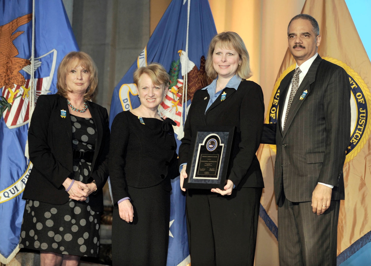 Dr. Charlotte Moerbe (second from right), Joint Base San Antonio sexual assault response coordinator, receives a Federal Service Award during the National Crime Victims’ Service Awards ceremony April 8 in Washington, D.C. Dr. Moerbe was recognized for her work supporting military members recovering from sexual violence. She is joined by, from left, Joye Frost, Acting Director, Office for Victims of Crime; Laurie Robinson, Assistant Attorney General, Office of Justice Programs; and Attorney General Eric Holder. (Photo by/Scott Ash)