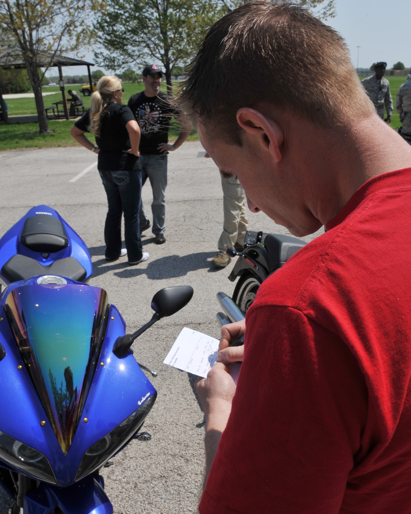 David Grey, Sport Bike Track Time, helps judge a sport bike for the motorcycle contest as part of Motorcycle Safety Day at Scott Air Force Base, Ill., April 14, 2011. The contest consisted of categories in sport, cruiser, and a best in show.  (U.S. Air Force photo/Senior Airman Tristin English)