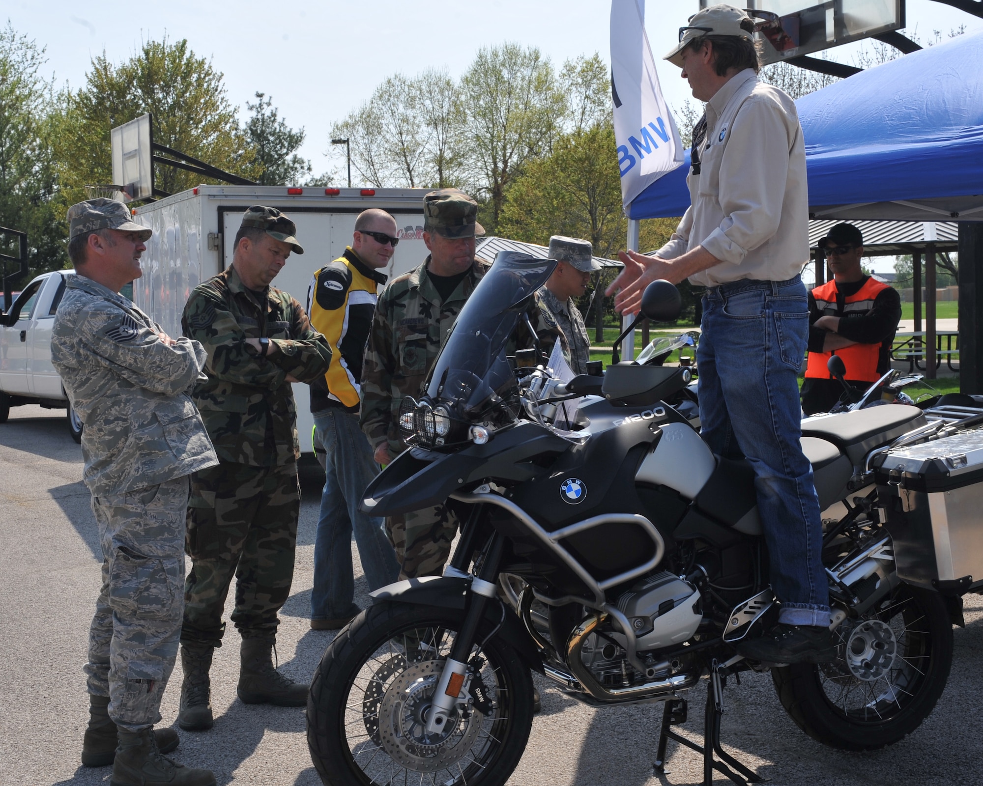 Bob Honz, Gateway BMW, shows a few members of Scott the weight and balance of the BMW R1200GS Adventure at Scott Air Force Base, Ill., April 14, 2011. The Adventure can be taken anywhere, from the road, to the woods or up in the mountains. (U.S. Air Force photo/Senior Airman Tristin English)