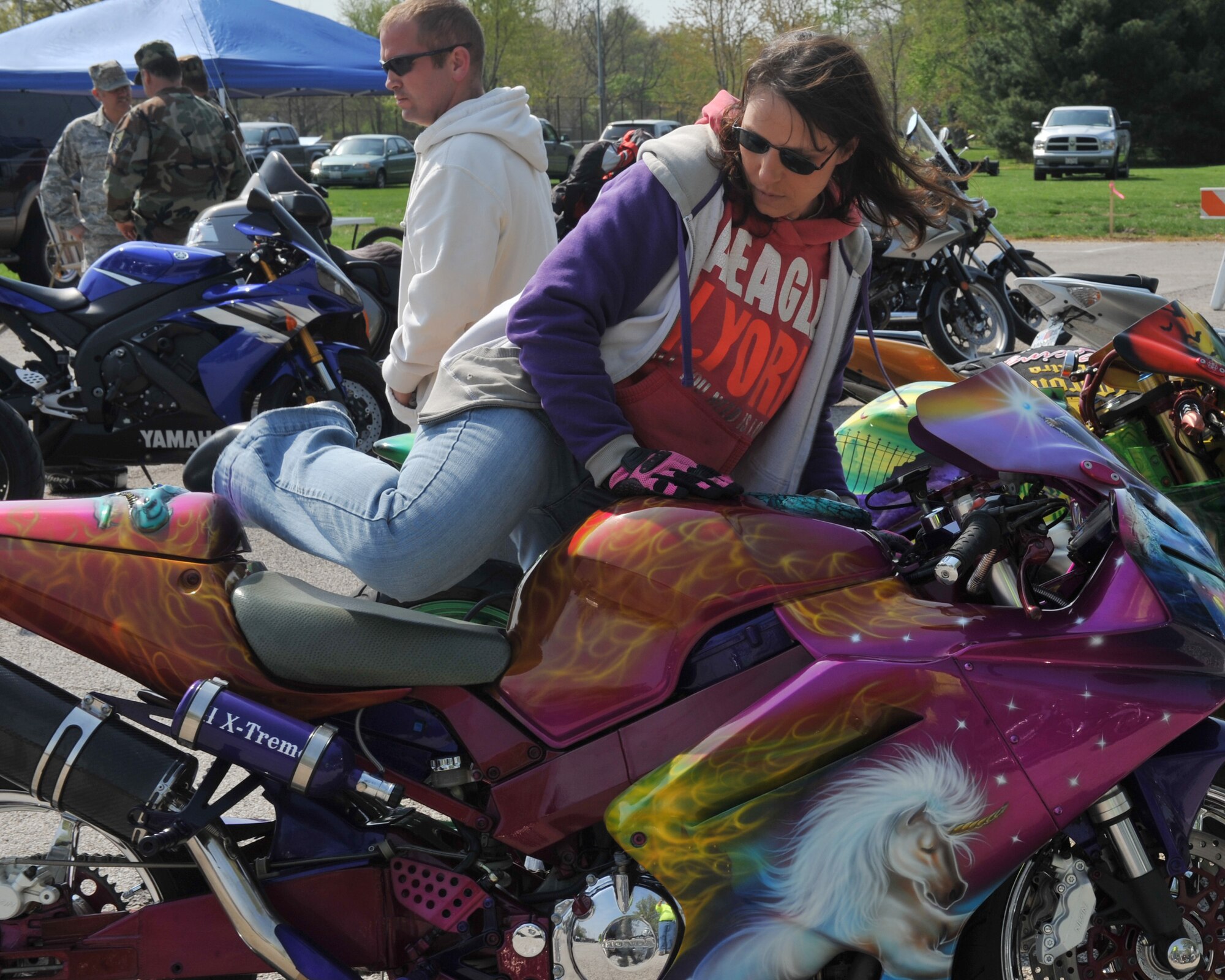 Master Sgt. Ramona Eads, Headquarters Air Mobility Command command fleet manager, dismounts her Honda CBR929, "The Wizard" during the Motorcycle Safety Day at Scott Air Force Base, Ill., April 14, 2011. Sergeant Eads came in first place during the sports bike contest, beating her husband who came in second. (U.S. Air Force photo/ Senior Airman Tristin English)